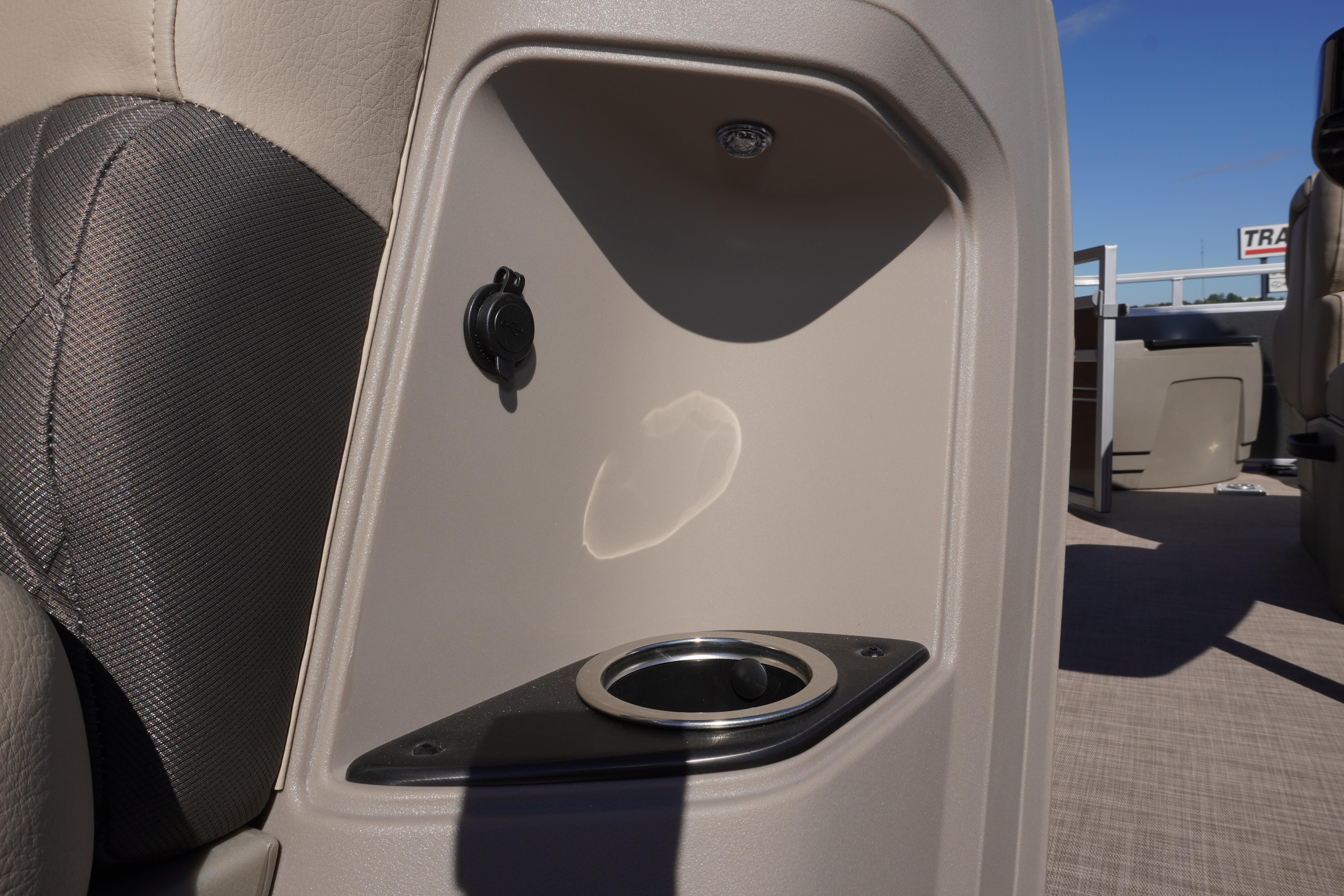 2024 Sun Tracker Fishin' Barge 20 DLX interior with cup holder and power outlet.