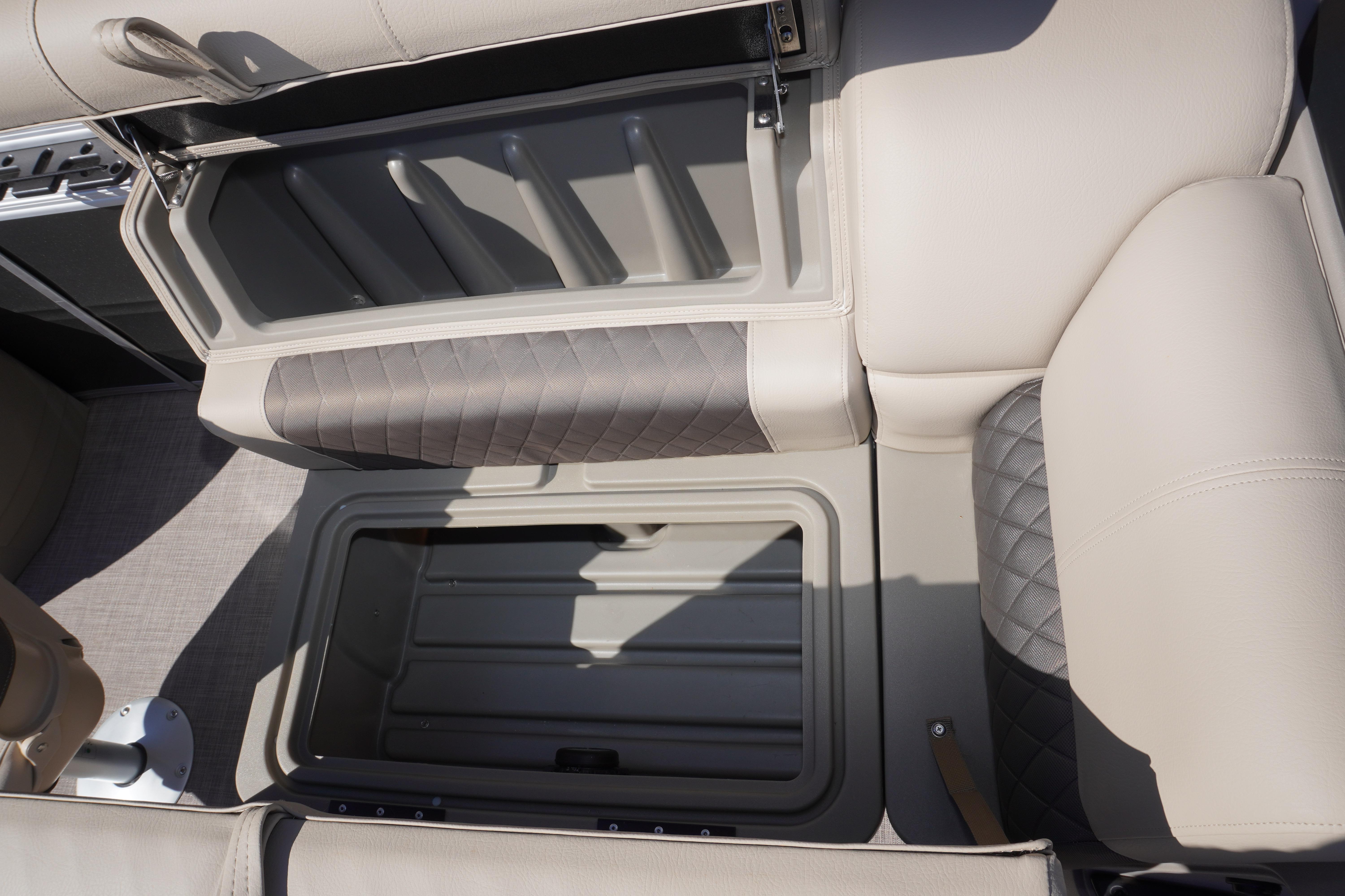 2024 Sun Tracker Fishin' Barge 20 DLX storage compartment with cushioned seating.