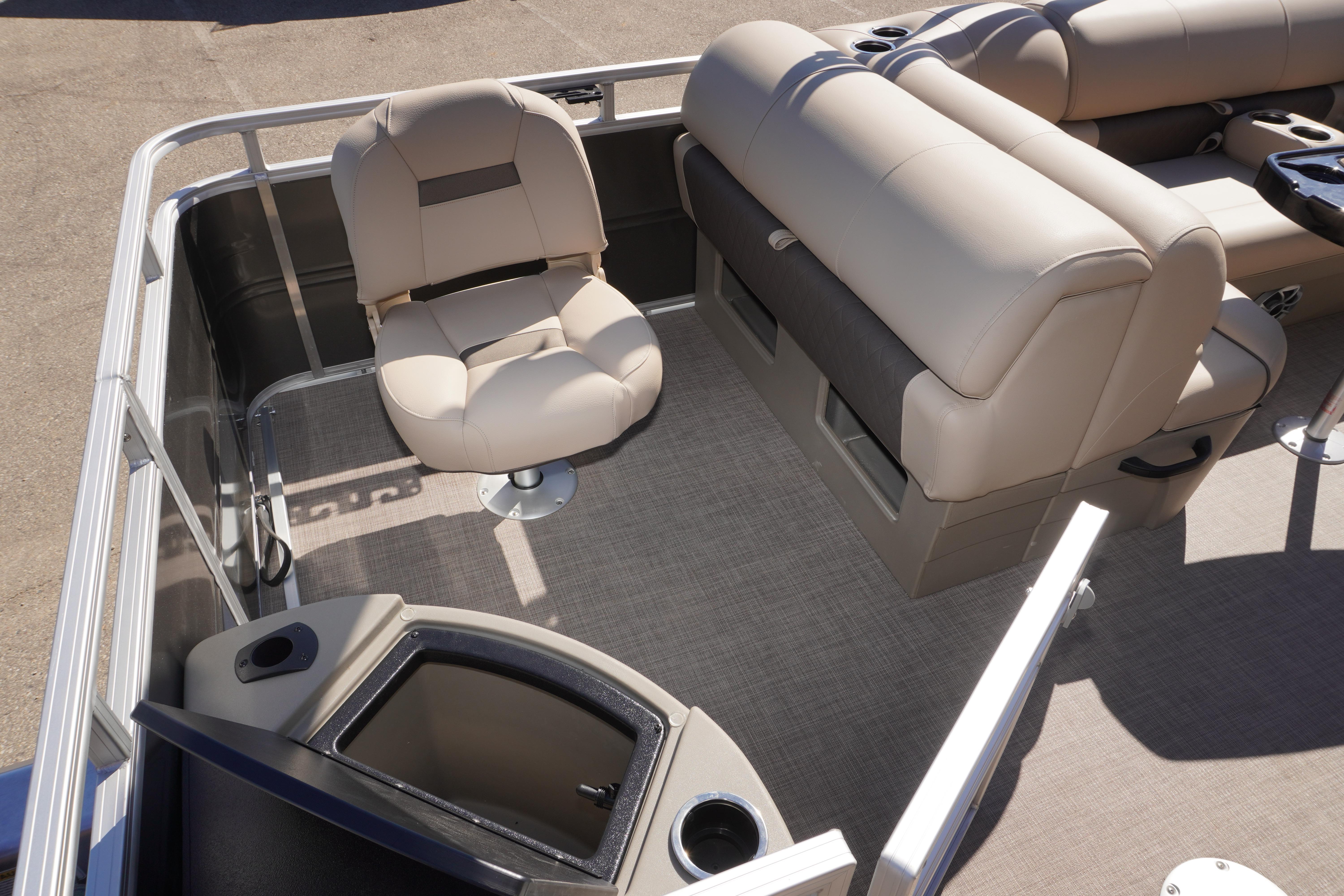 2024 Sun Tracker Fishin' Barge 20 DLX interior with beige seating and storage compartments.