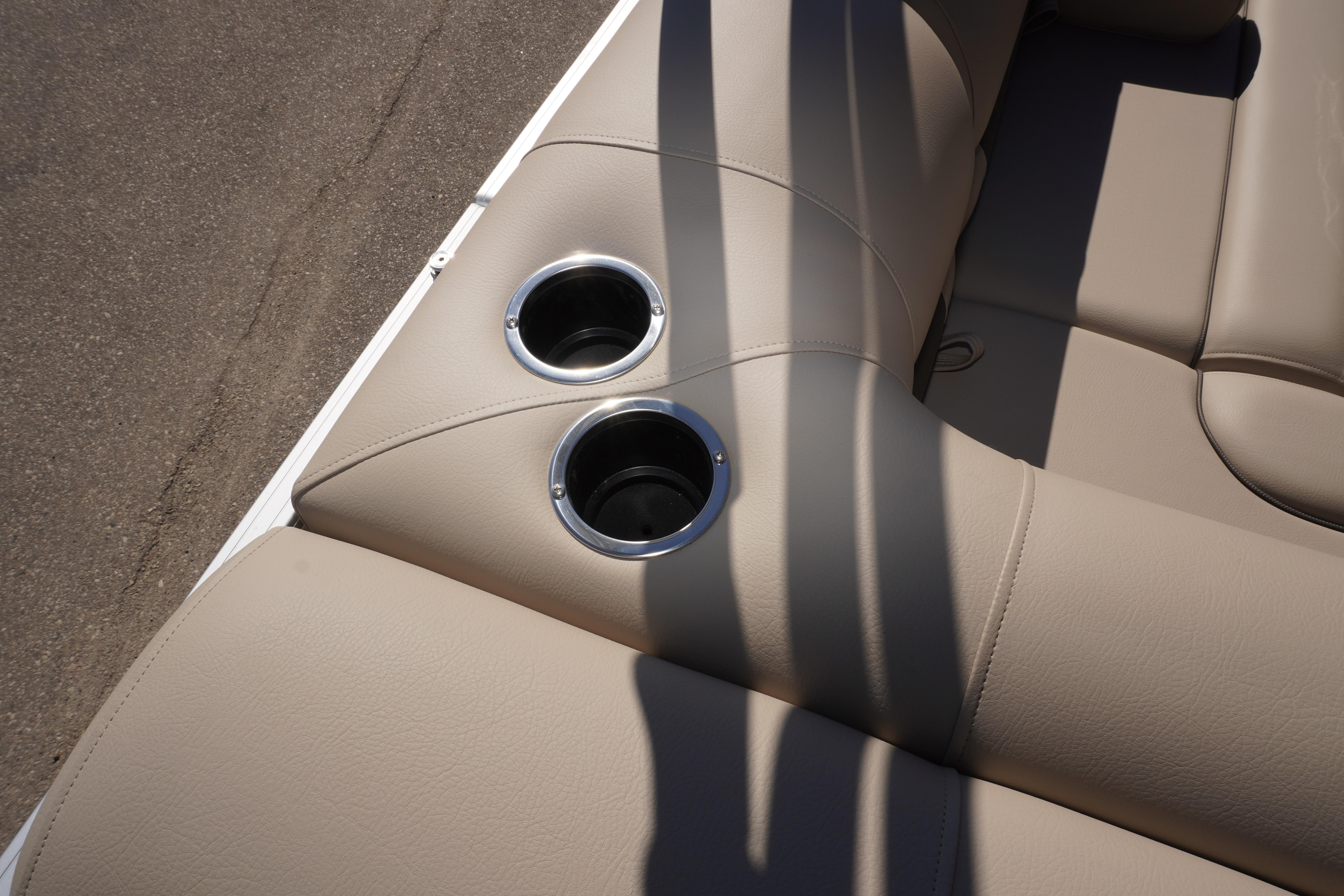 2024 Sun Tracker Fishin' Barge 20 DLX beige seating with dual cup holders.