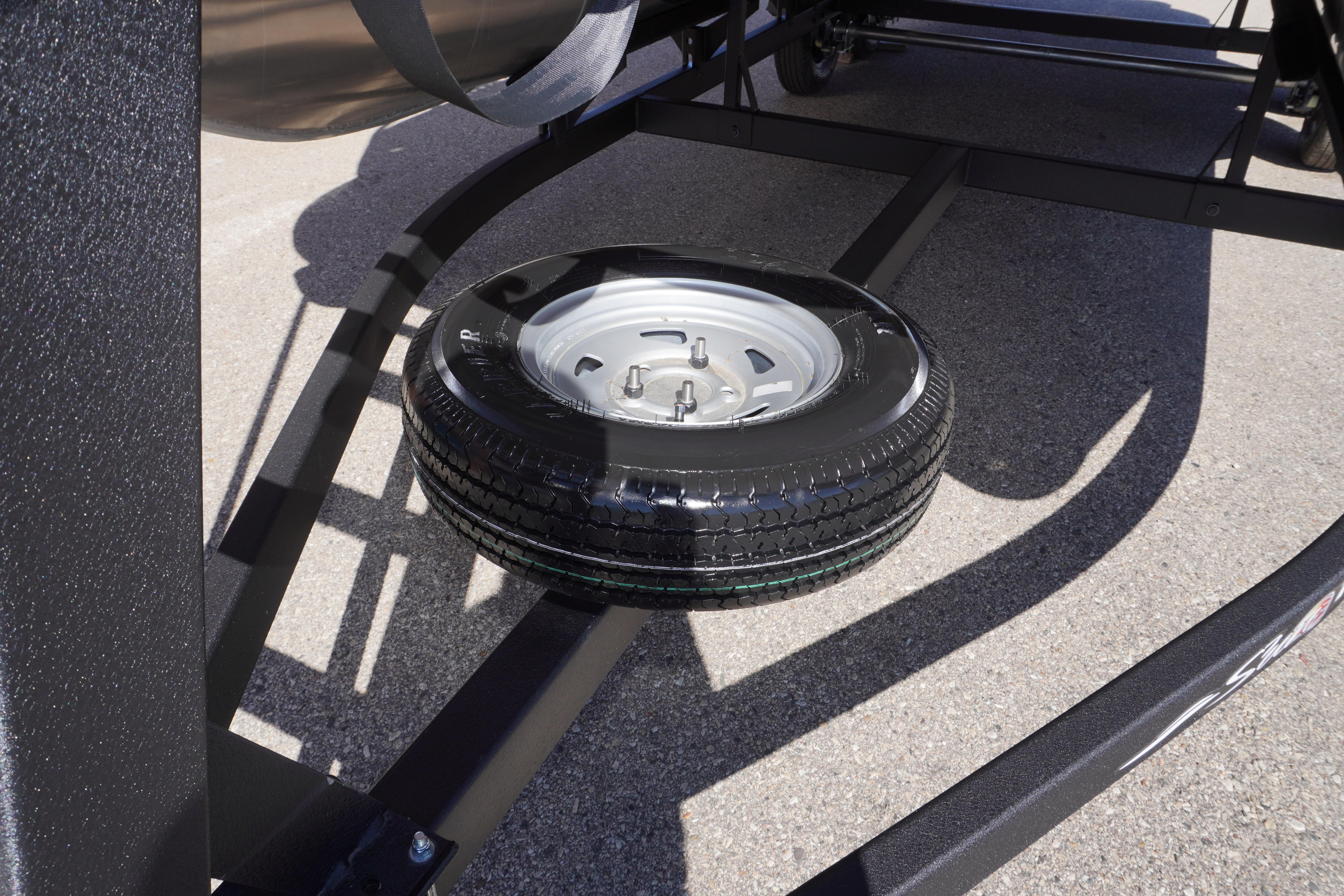 2024 Sun Tracker Fishin' Barge 20 DLX trailer with spare tire mounted underneath.