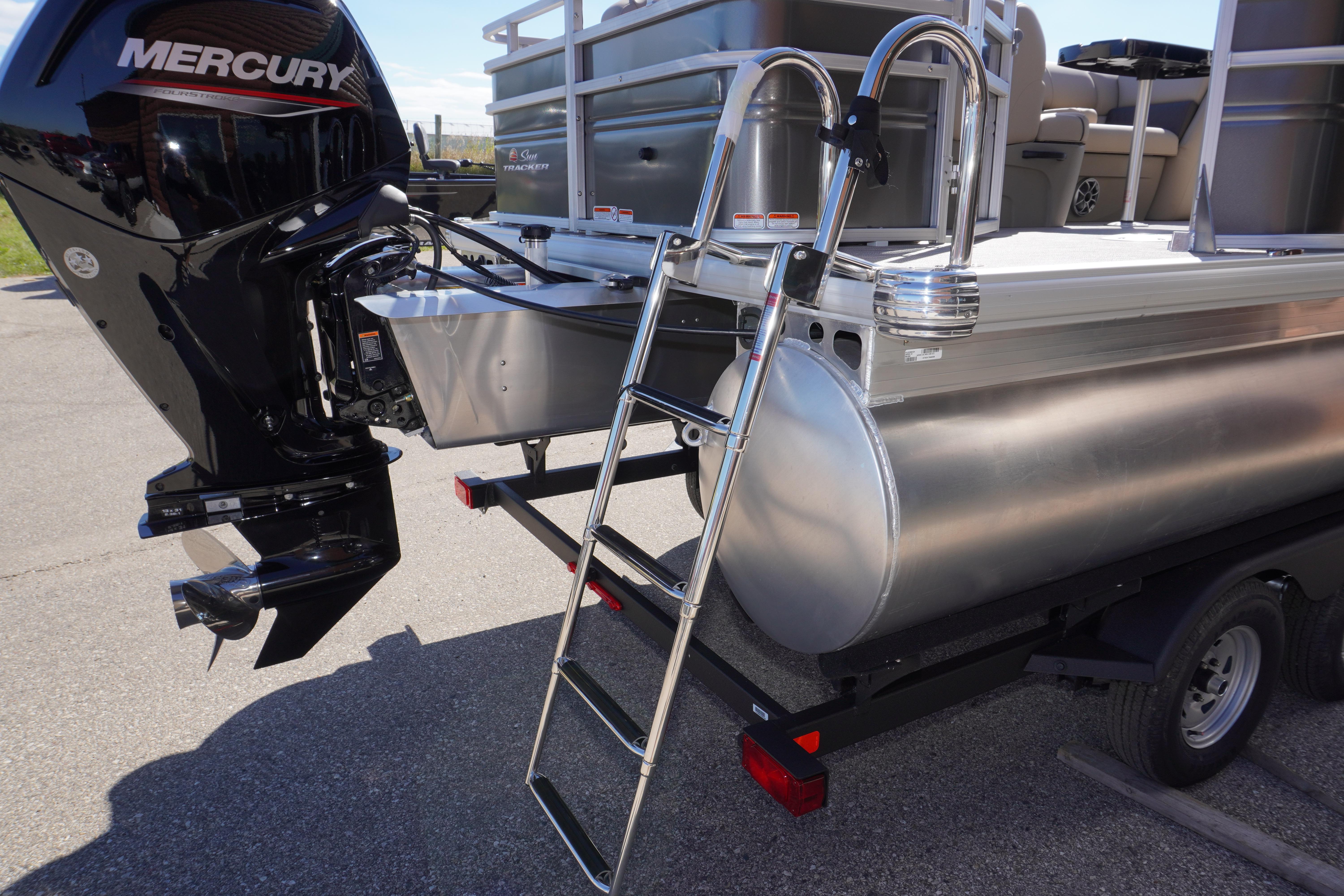 2024 Sun Tracker Fishin' Barge 20 DLX with Mercury engine and ladder on trailer.