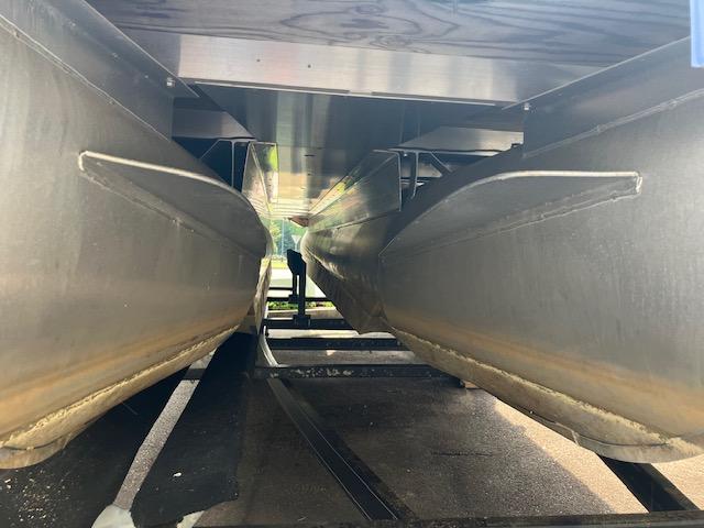 Underneath view of a 2007 Bennington 2275QXi pontoon boat, showcasing dual pontoons.