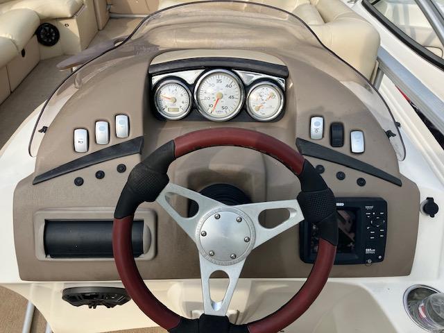 Steering console of a 2007 Bennington 2275QXi boat with gauges and controls.