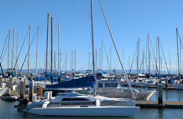 Sailboats docked at marina, featuring a 1996 Corsair F-31 trimaran in the foreground.