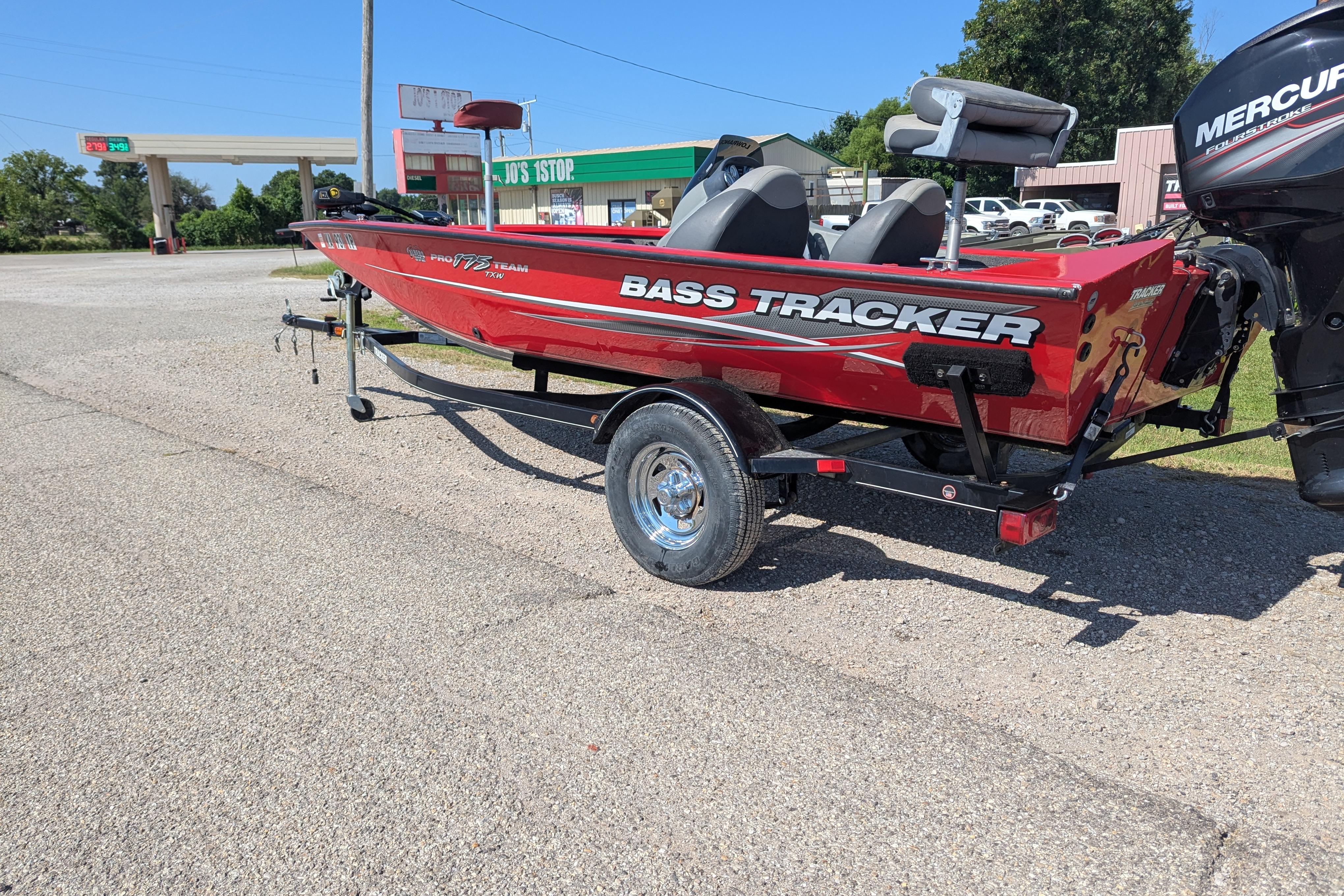 2015 Tracker Pro Team 175 TXW boat on trailer, parked near a gas station.