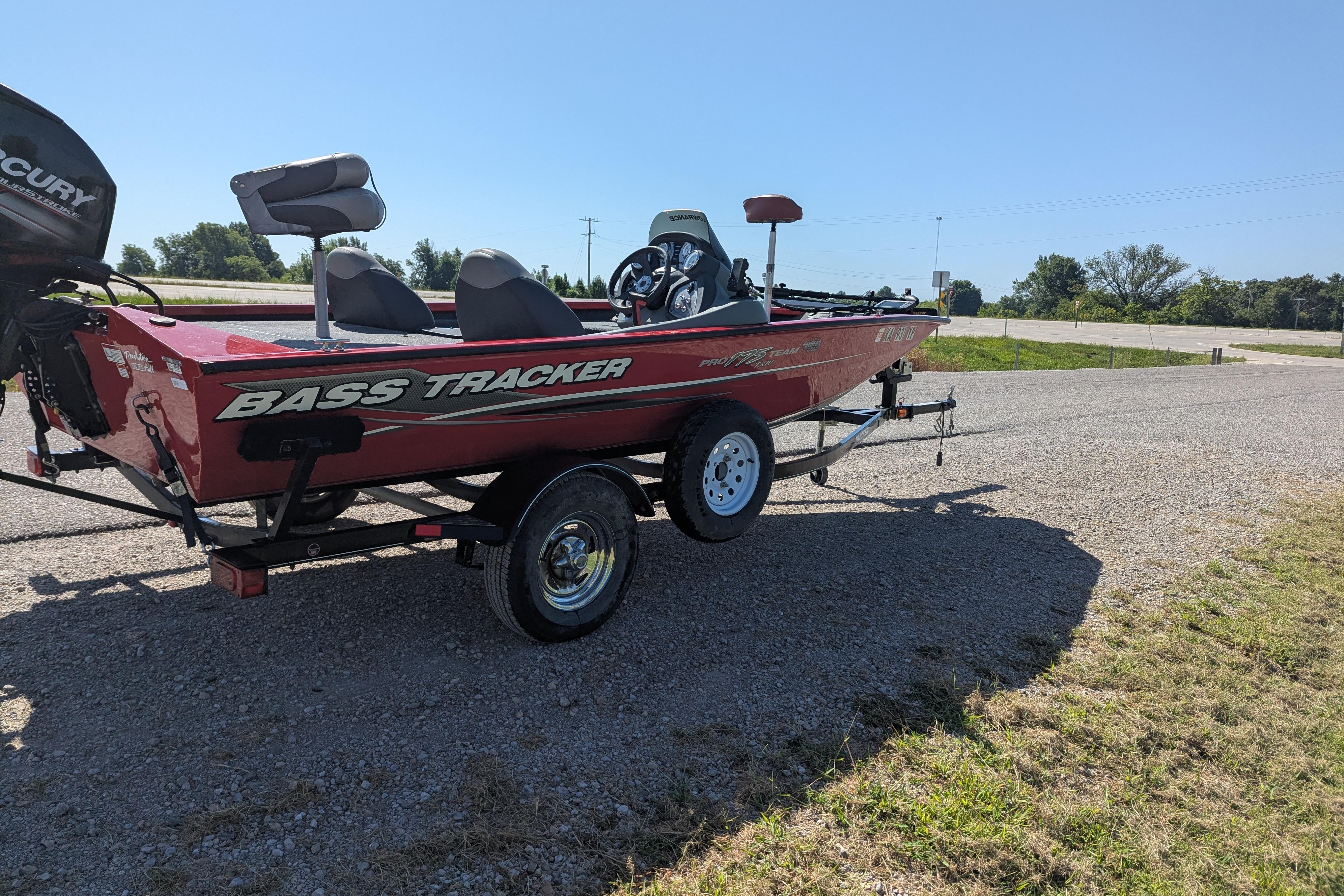 2015 Tracker Pro Team 175 TXW bass boat on trailer, parked on gravel road.