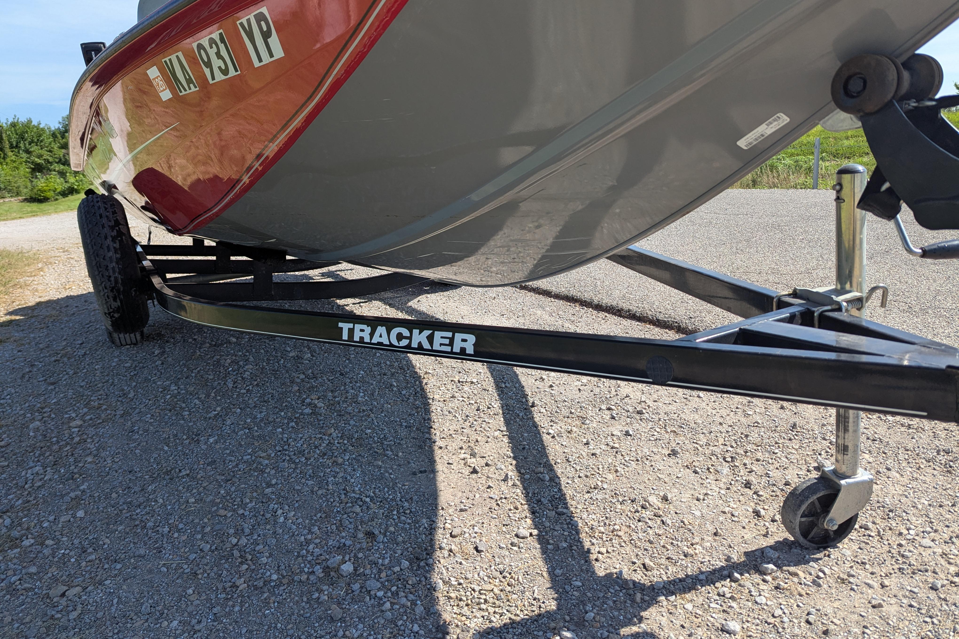 2015 Tracker Pro Team 175 TXW boat on trailer, parked on gravel road.