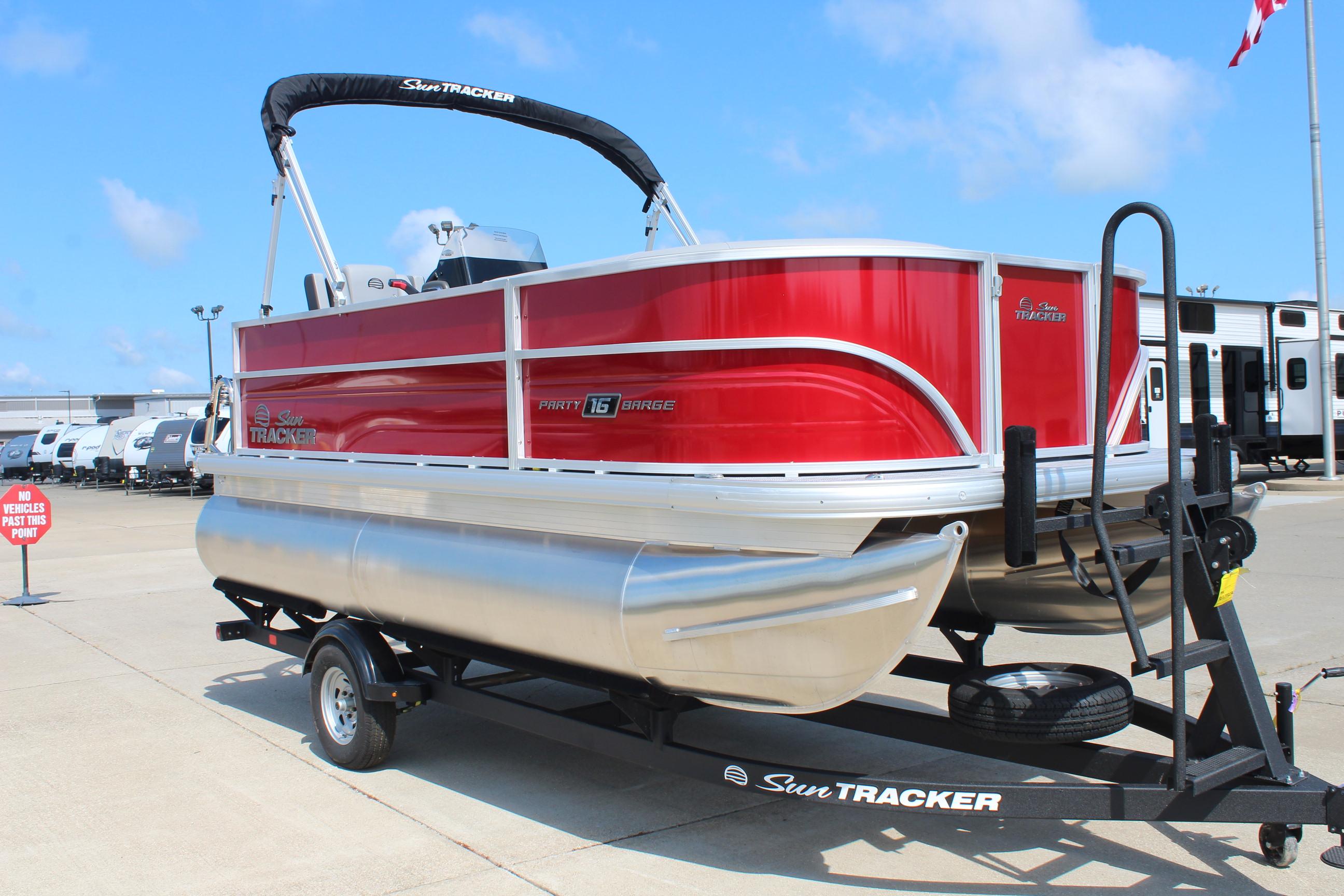 2026 Sun Tracker Party Barge 16 DLX pontoon boat on trailer, vibrant red exterior.
