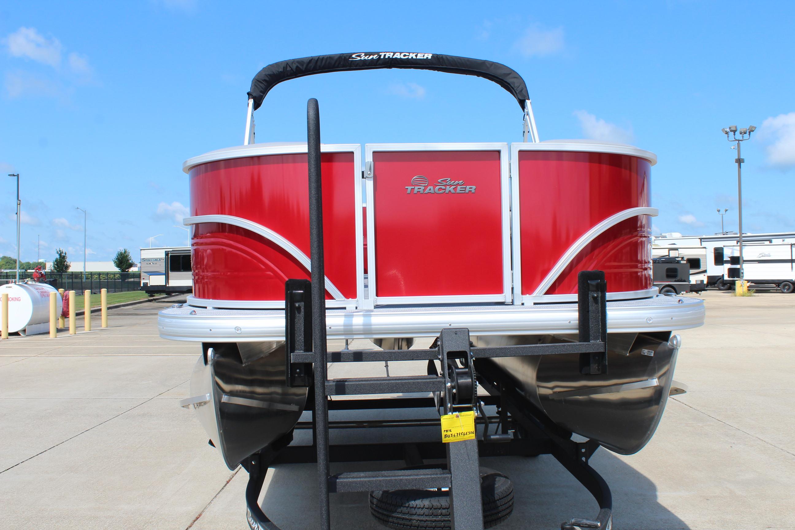 2026 Sun Tracker Party Barge 16 DLX pontoon boat in vibrant red on trailer.