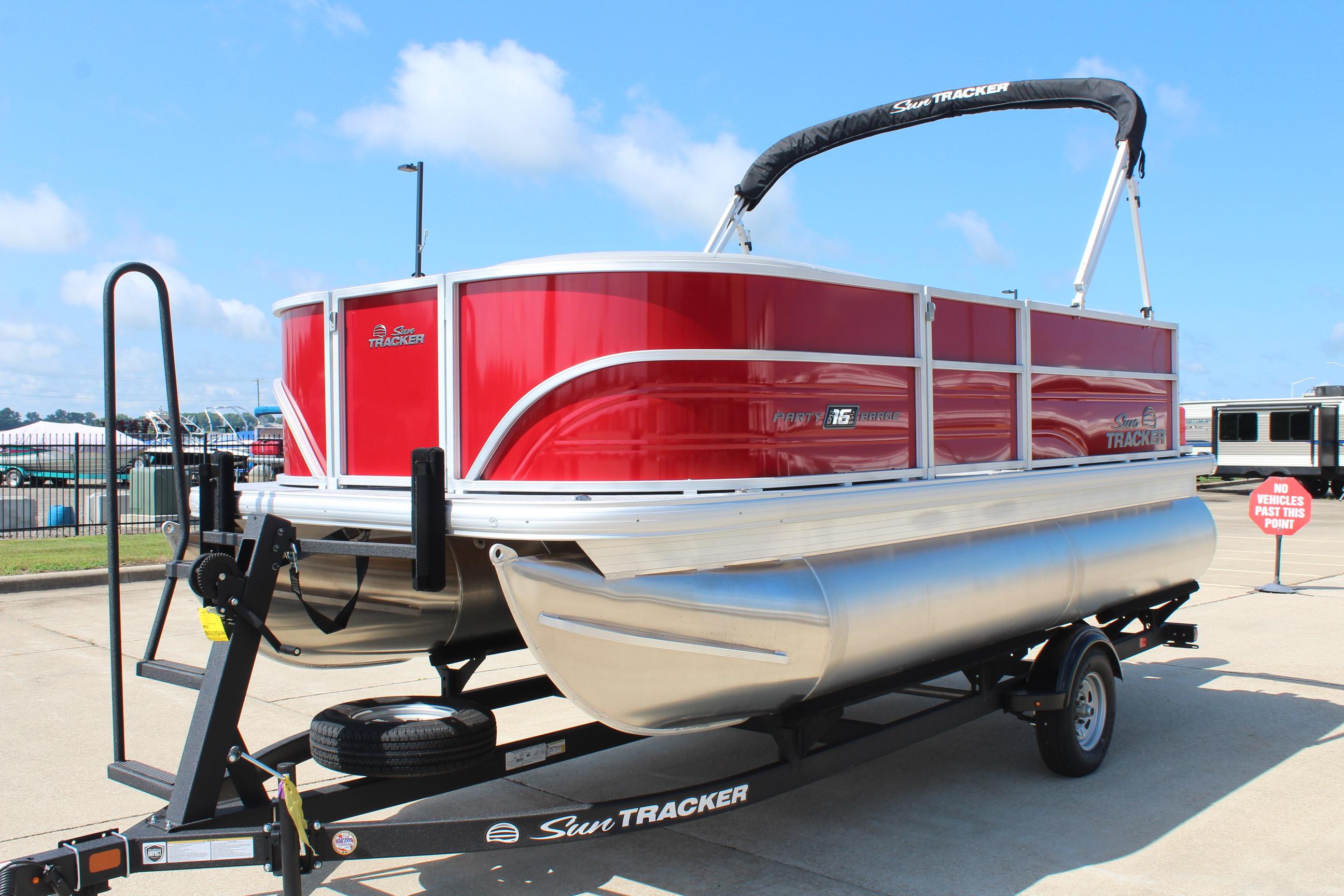2026 Sun Tracker Party Barge 16 DLX pontoon boat on trailer, vibrant red exterior.