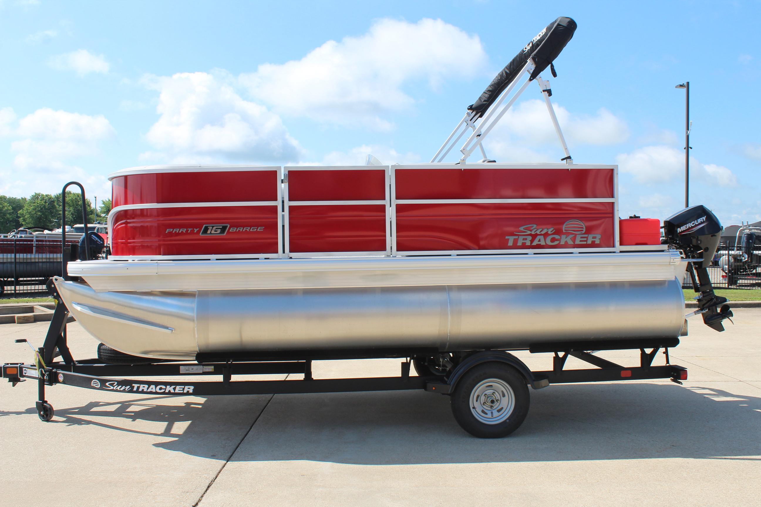 2026 Sun Tracker Party Barge 16 DLX pontoon boat on trailer, red and silver design.