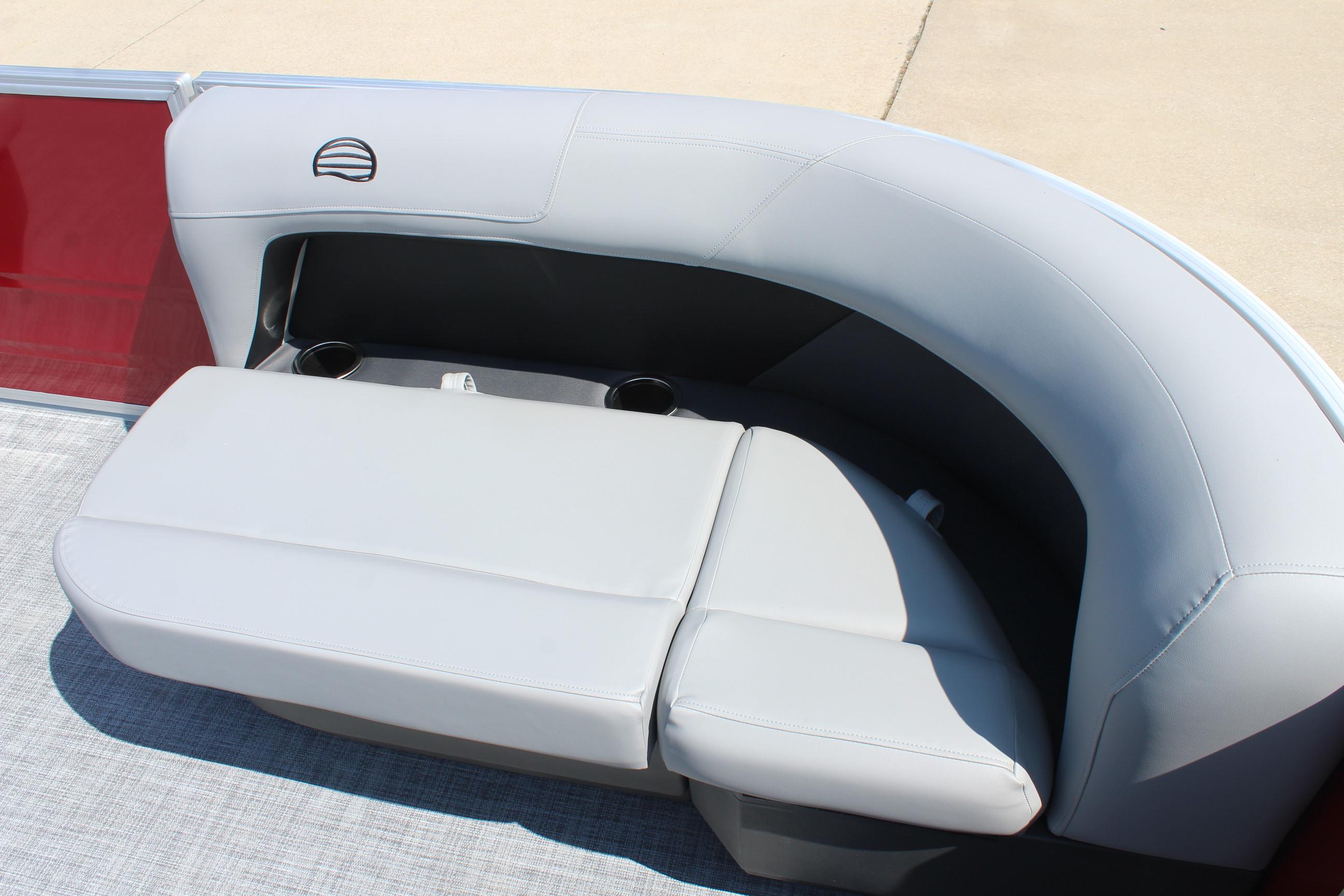 2026 Sun Tracker Party Barge 16 DLX, gray seating with cup holders, red paneling.