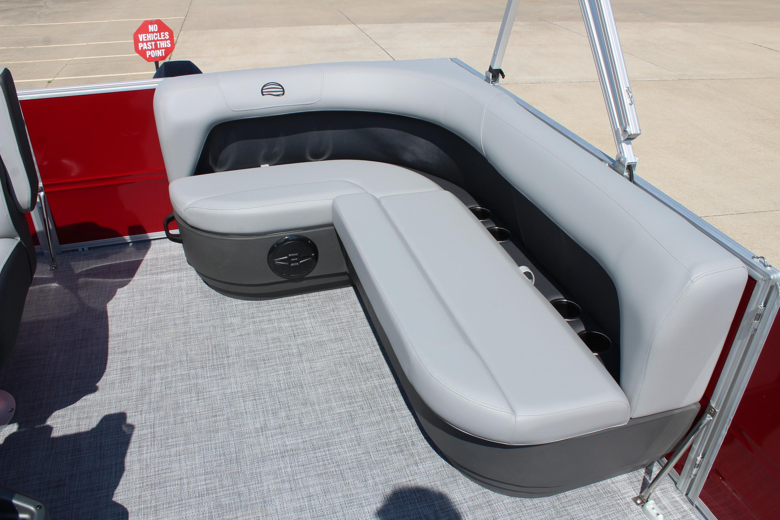 2026 Sun Tracker Party Barge 16 DLX interior seating with gray upholstery and cup holders.