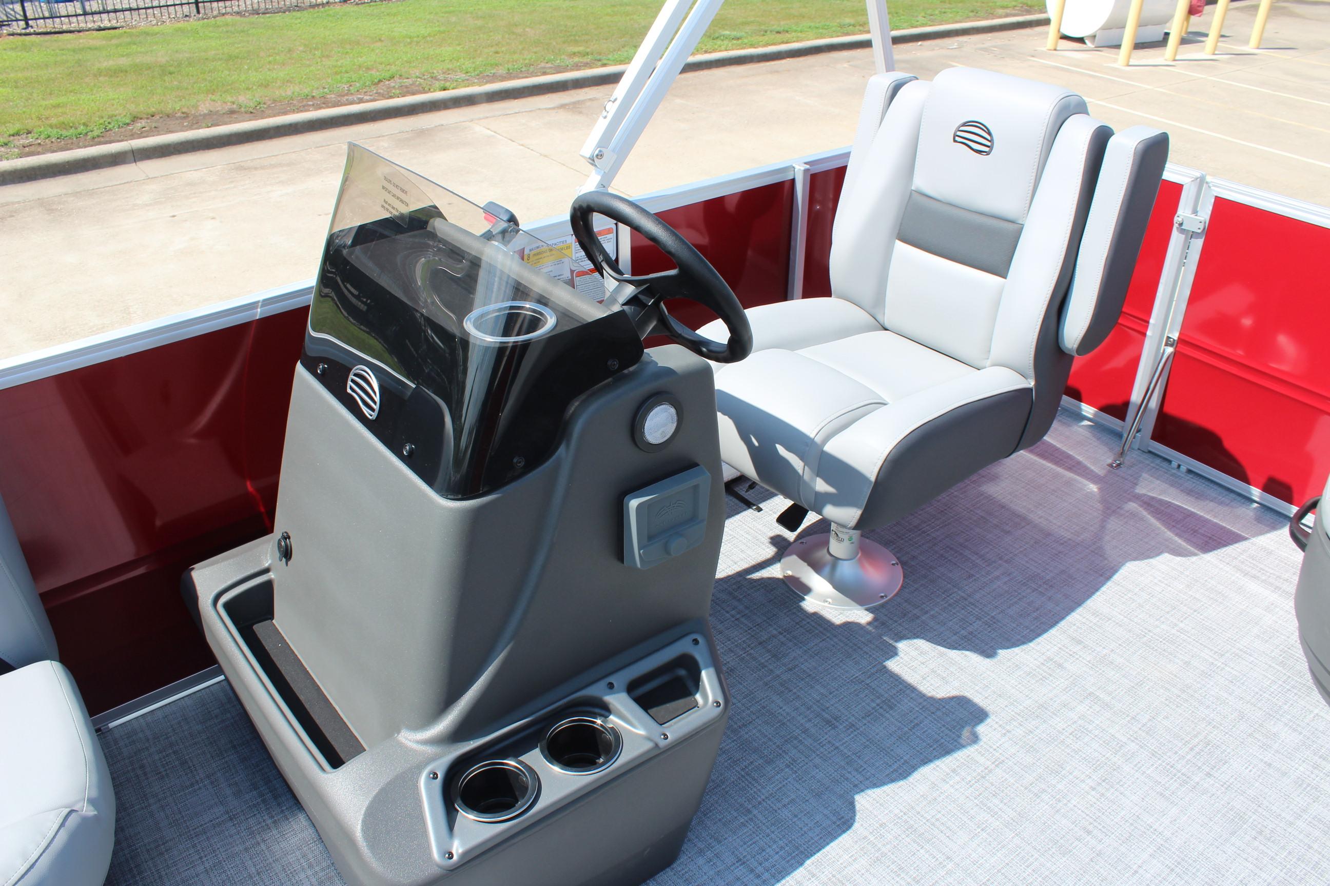 2026 Sun Tracker Party Barge 16 DLX interior with steering console and captain's chair.