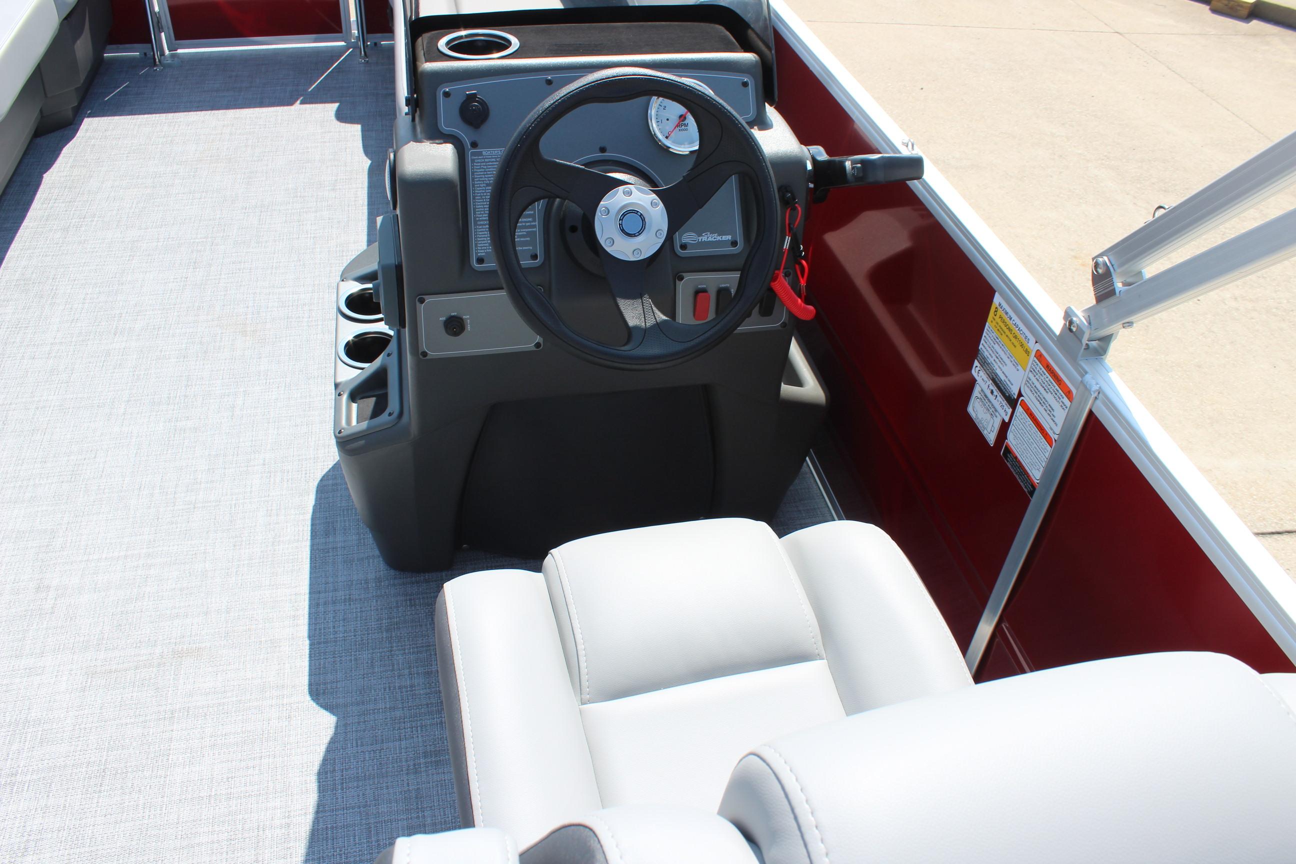 2026 Sun Tracker Party Barge 16 DLX steering console with comfortable seating and cup holders.