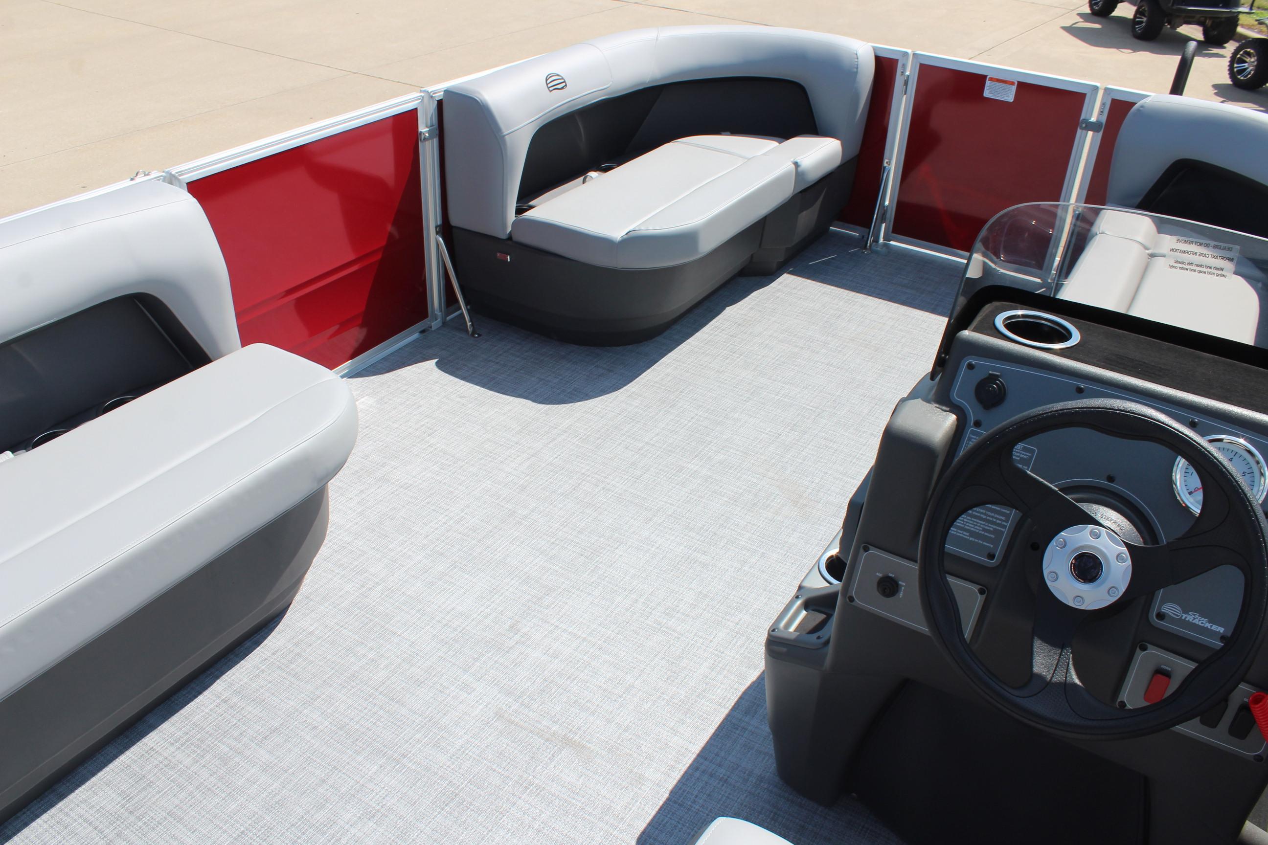2026 Sun Tracker Party Barge 16 DLX interior with gray seating and steering console.