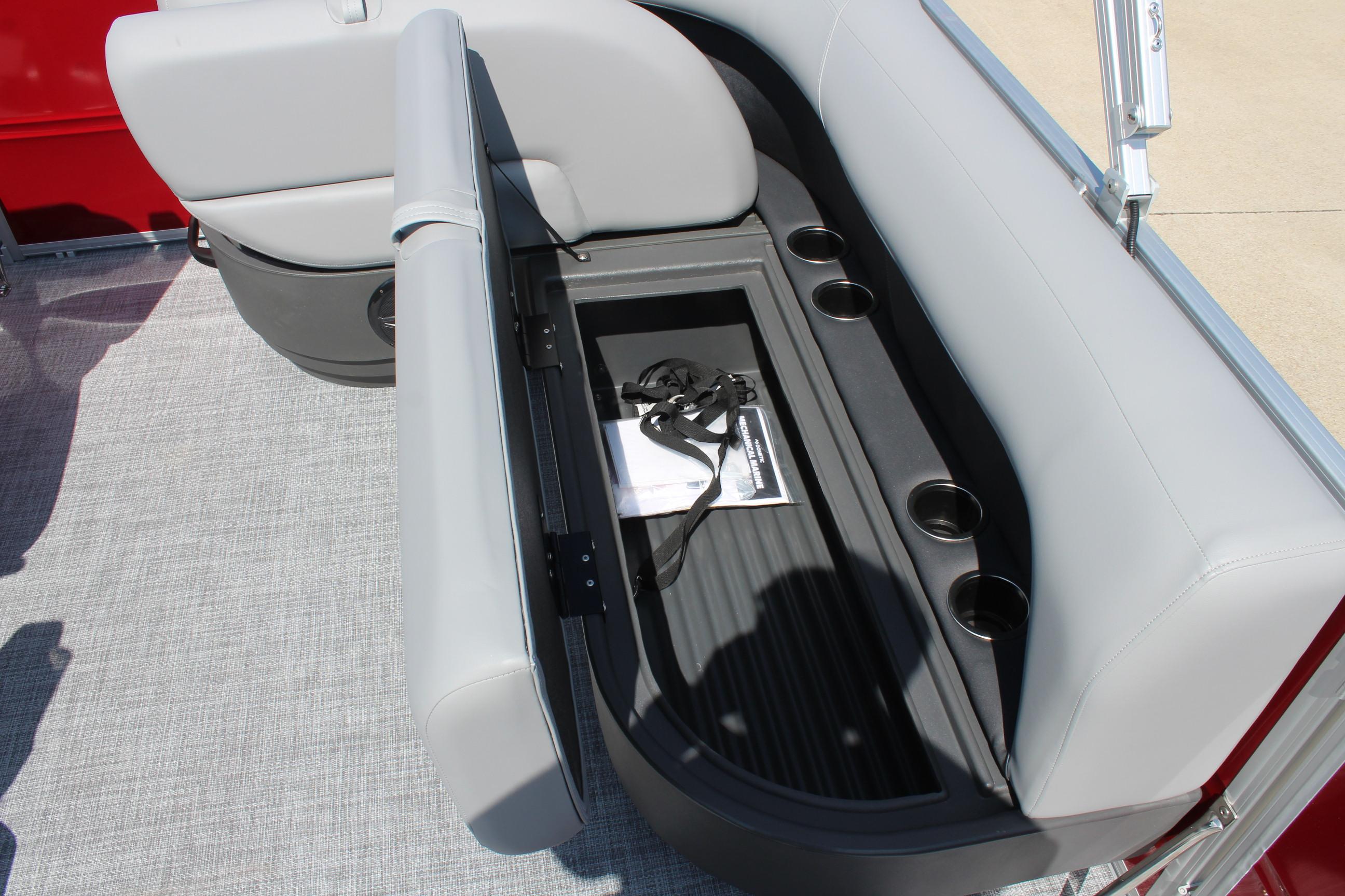 2026 Sun Tracker Party Barge 16 DLX seat storage with cup holders and accessories.