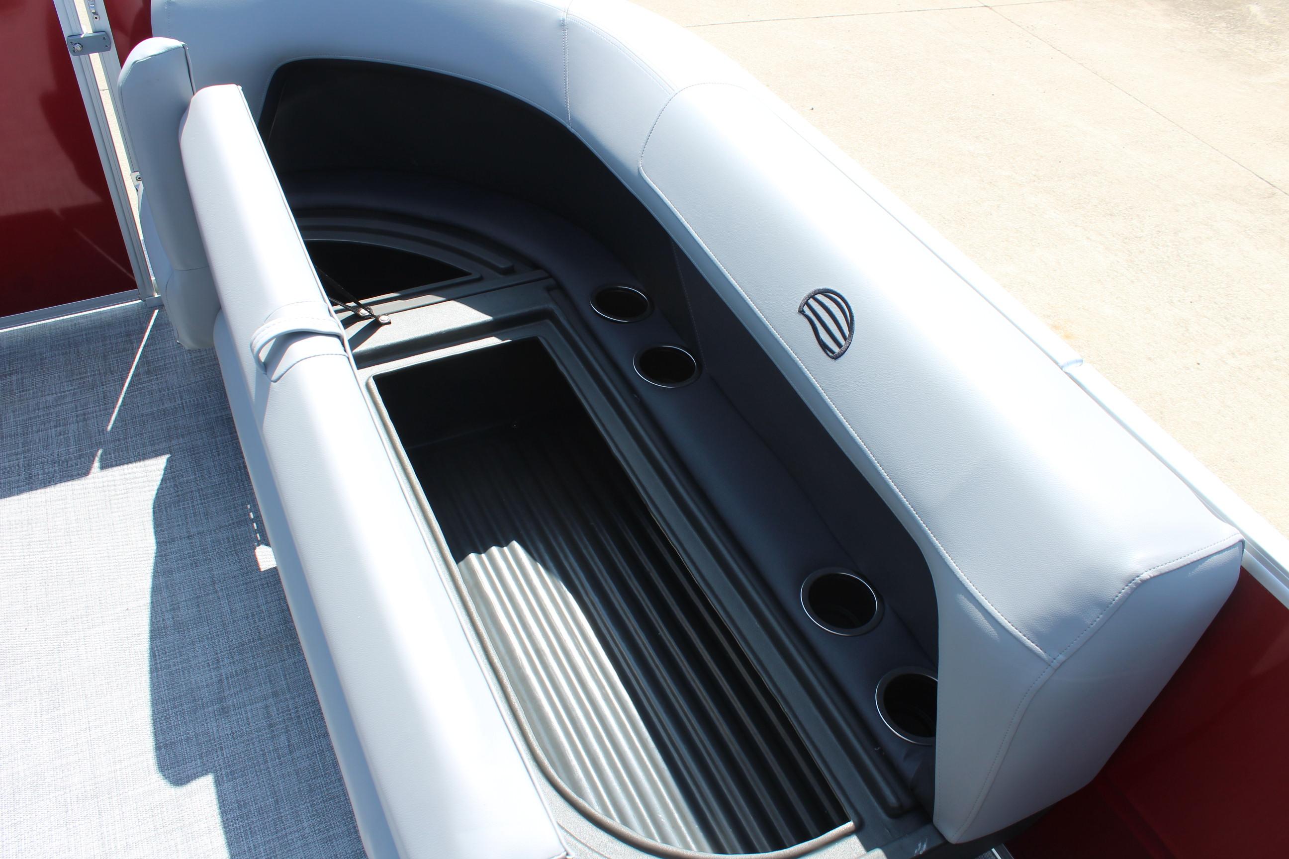 2026 Sun Tracker Party Barge 16 DLX interior seating with cup holders and storage.