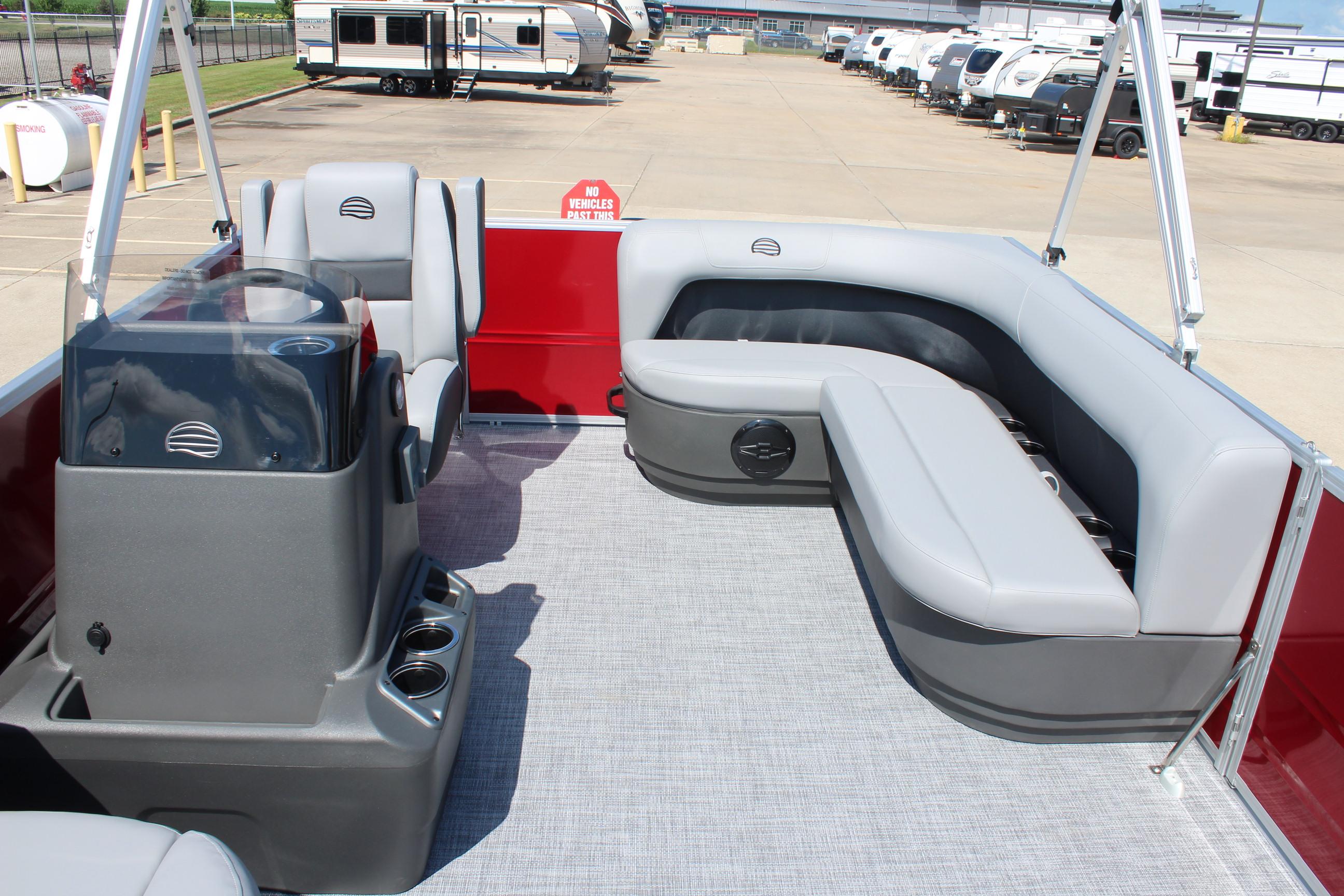 2026 Sun Tracker Party Barge 16 DLX interior with gray seating and red accents.