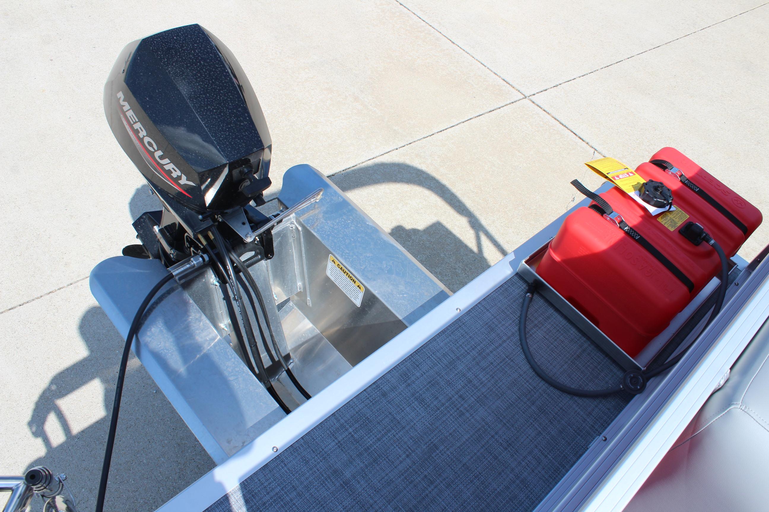 2026 Sun Tracker Party Barge 16 DLX with Mercury outboard motor and red fuel tanks.