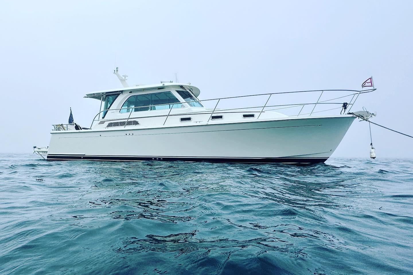 2019 Sabre 38 Salon Express yacht on calm ocean waters.