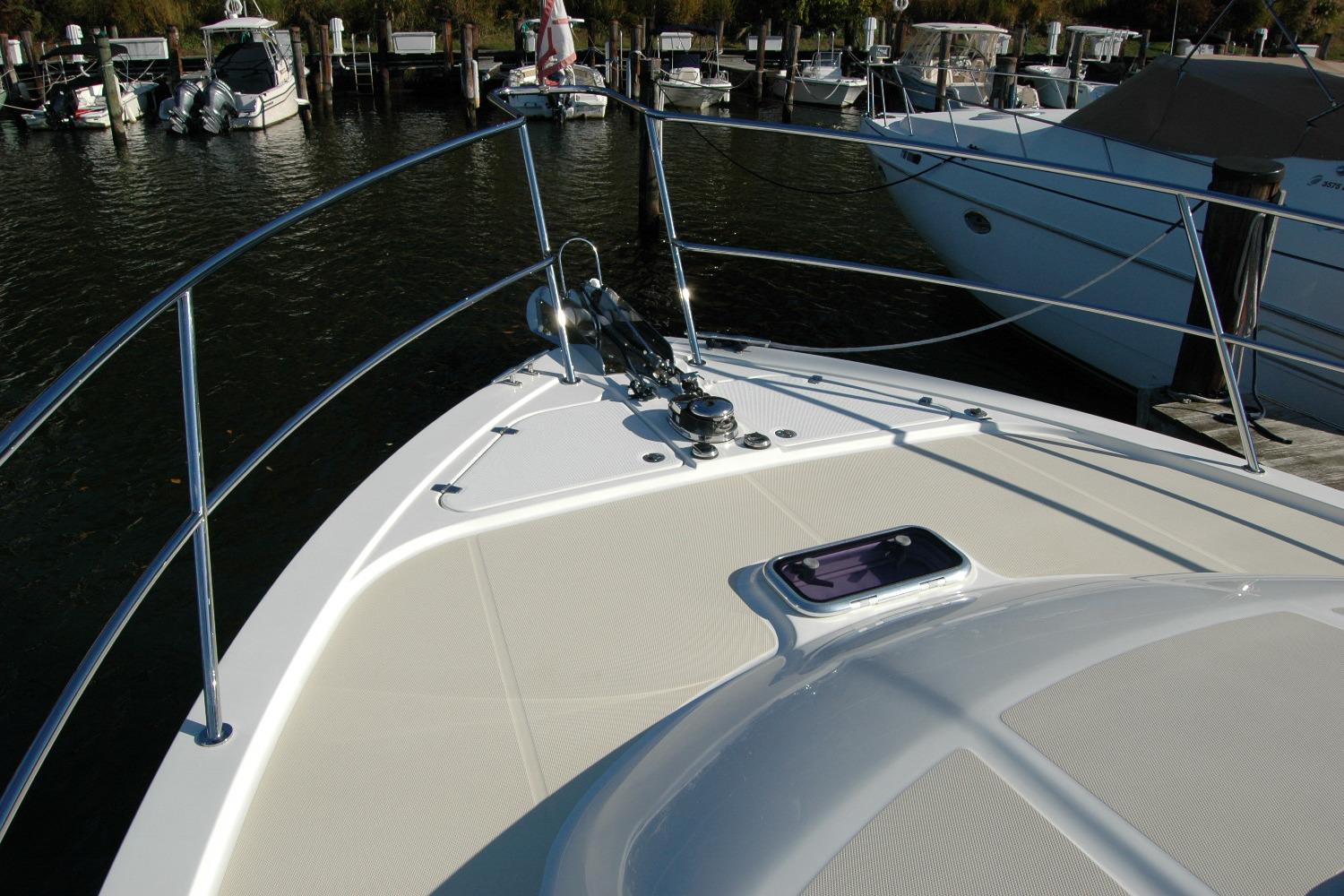 2019 Sabre 38 Salon Express yacht bow at marina, featuring sleek design and railing.