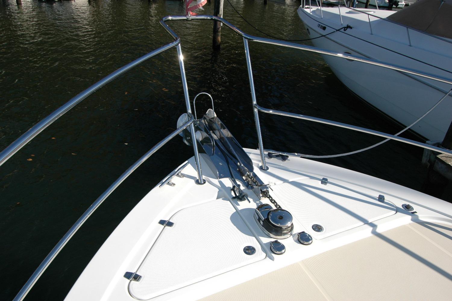 2019 Sabre 38 Salon Express bow with anchor and railing in marina.