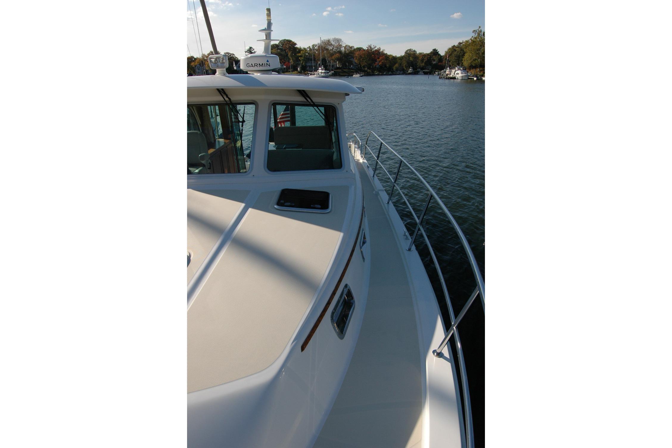 2019 Sabre 38 Salon Express yacht on calm water, side view.