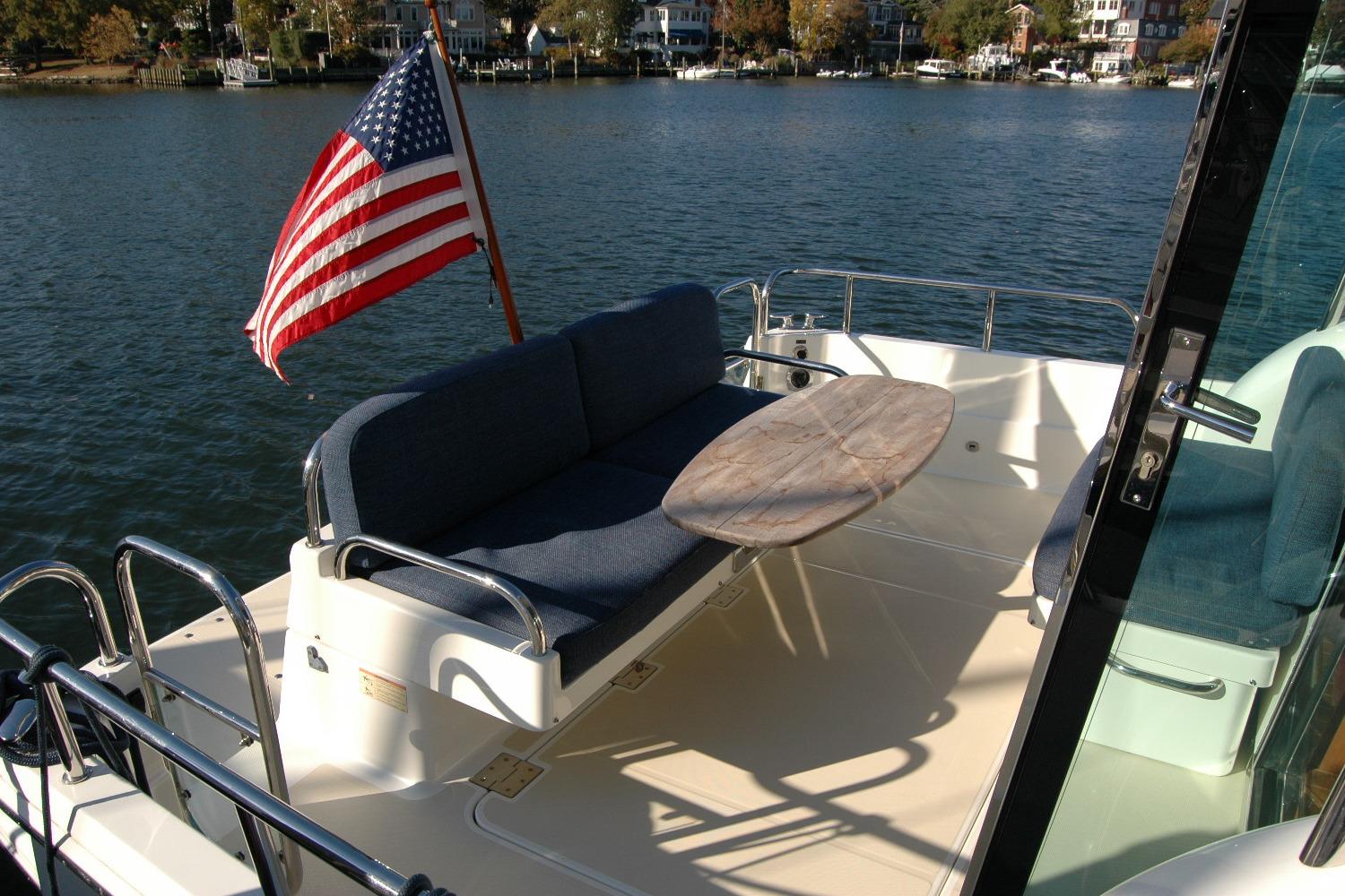 2019 Sabre 38 Salon Express yacht deck with American flag and seating area.