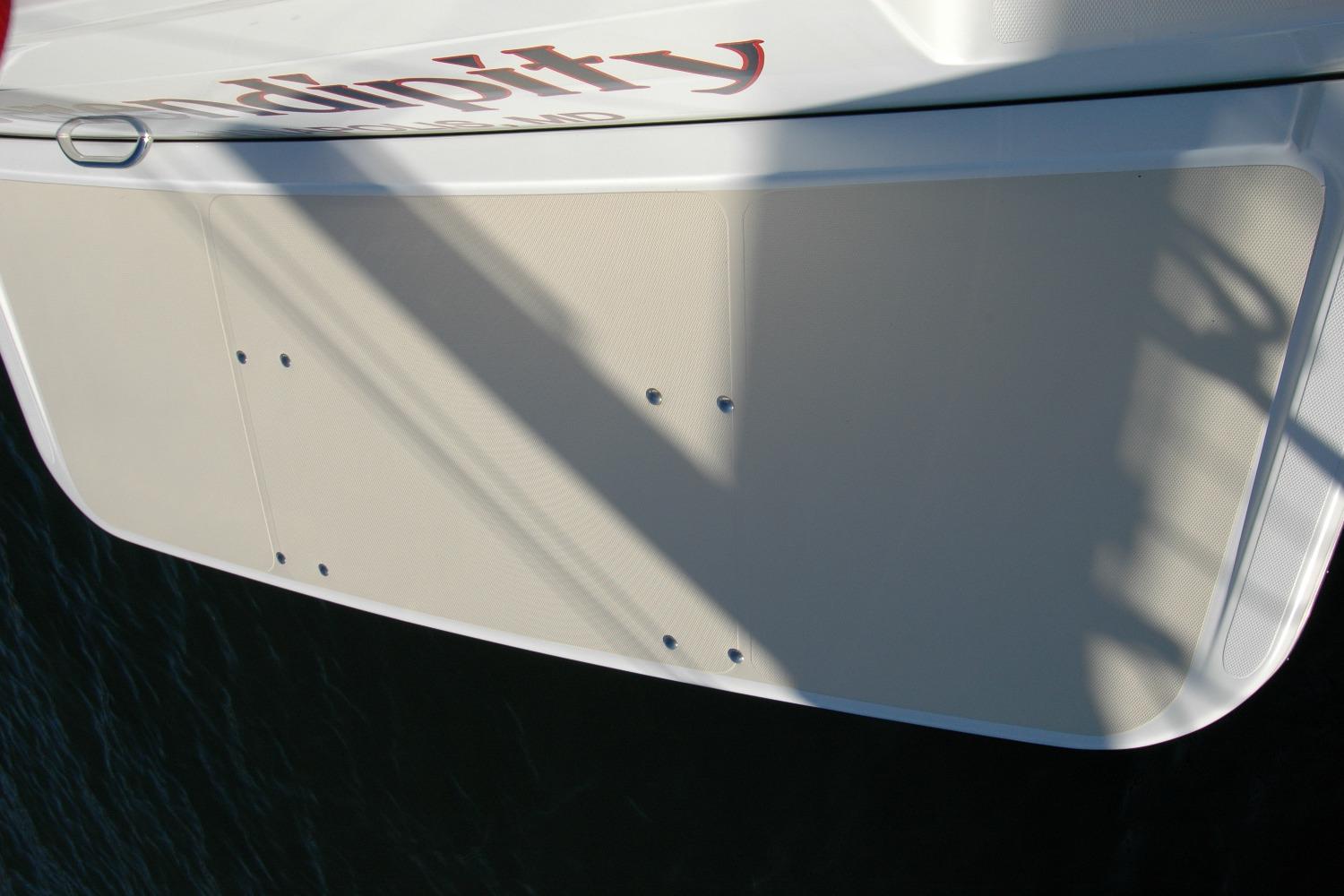 2019 Sabre 38 Salon Express boat stern platform with shadow and partial name visible.