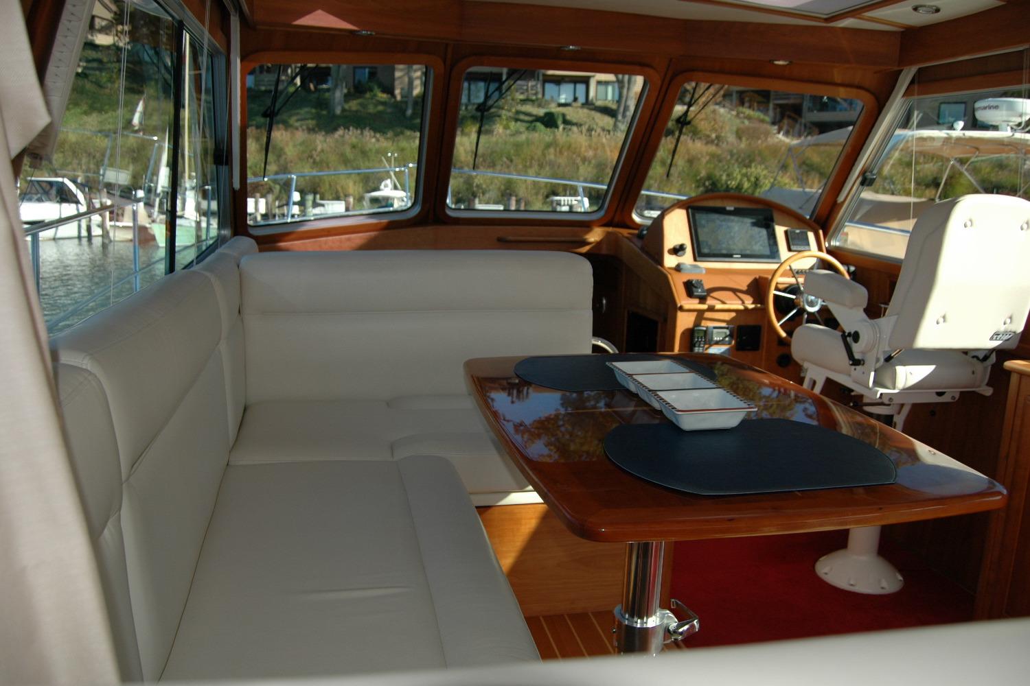 Interior of 2019 Sabre 38 Salon Express yacht with seating and helm station.