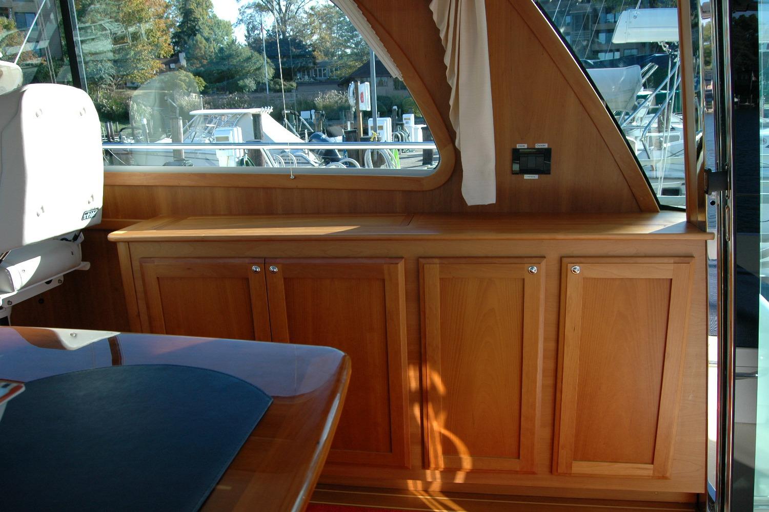 Interior of 2019 Sabre 38 Salon Express with wooden cabinetry and window view.