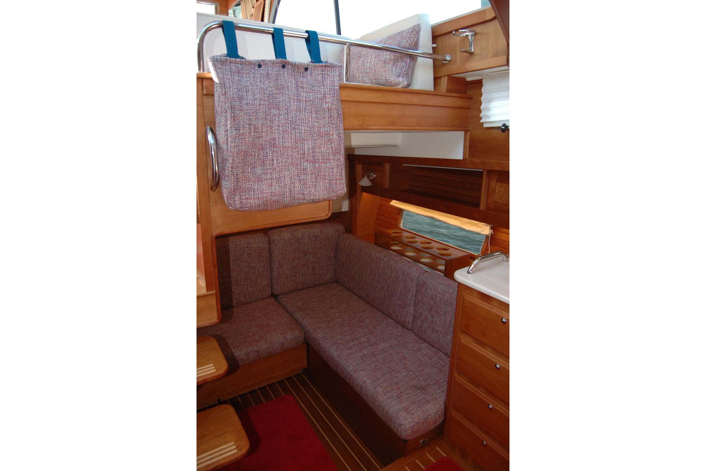Interior of 2019 Sabre 38 Salon Express with cozy seating and wooden cabinetry.