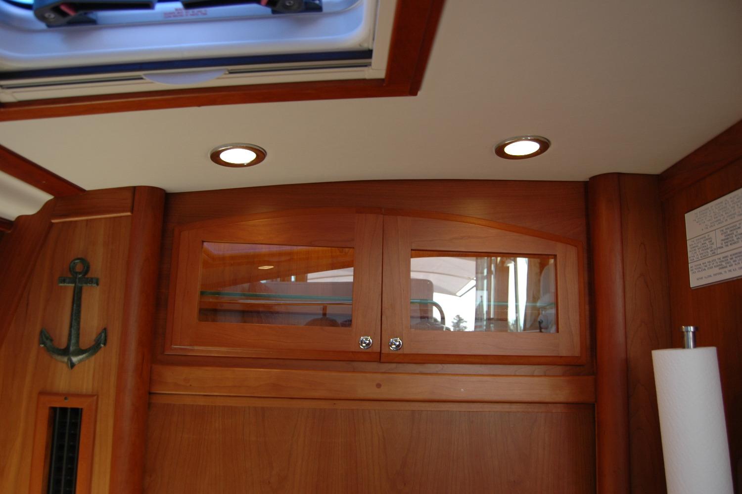 Interior of 2019 Sabre 38 Salon Express with wooden cabinets and anchor decor.