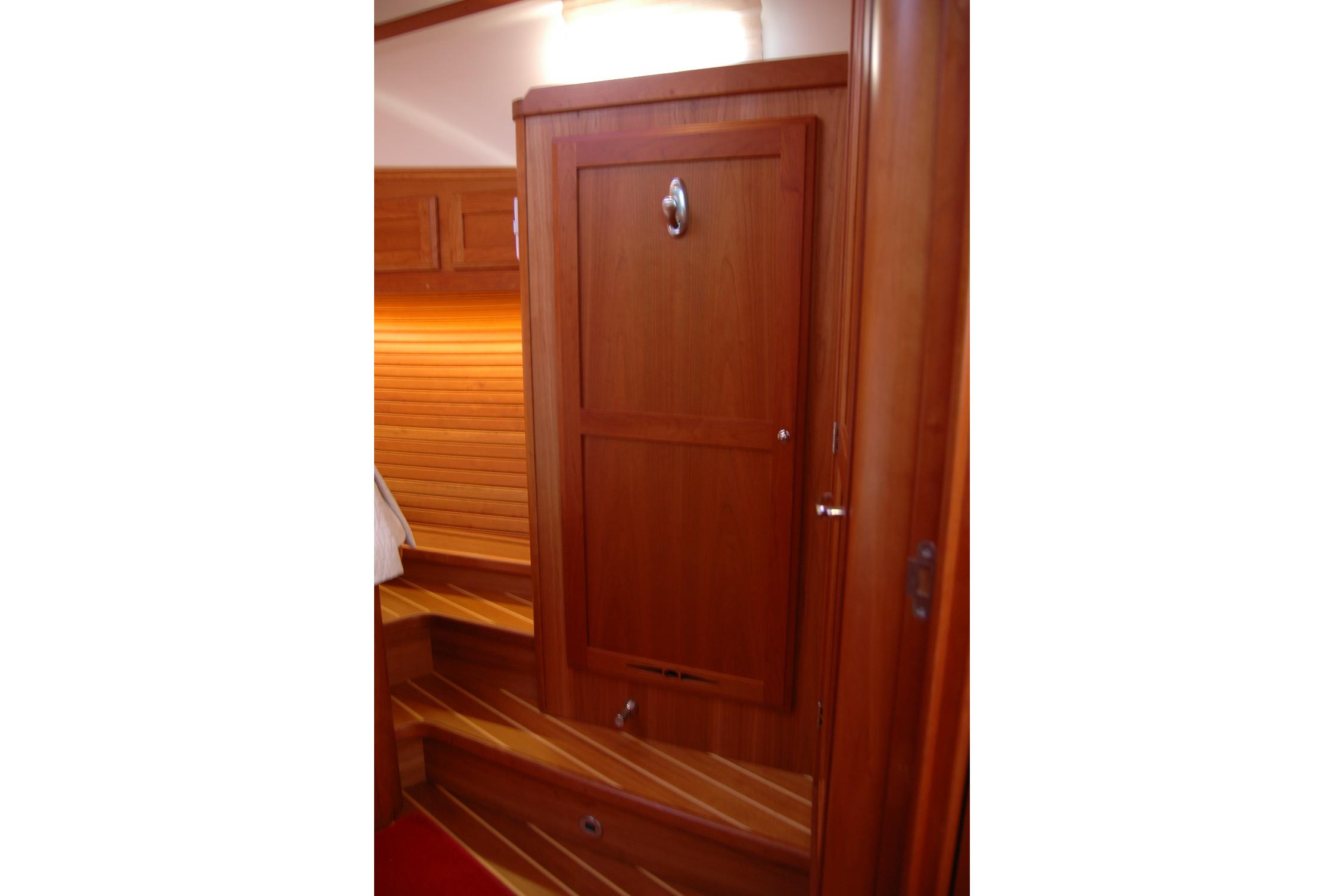 Interior of 2019 Sabre 38 Salon Express, featuring wooden cabinetry and steps.