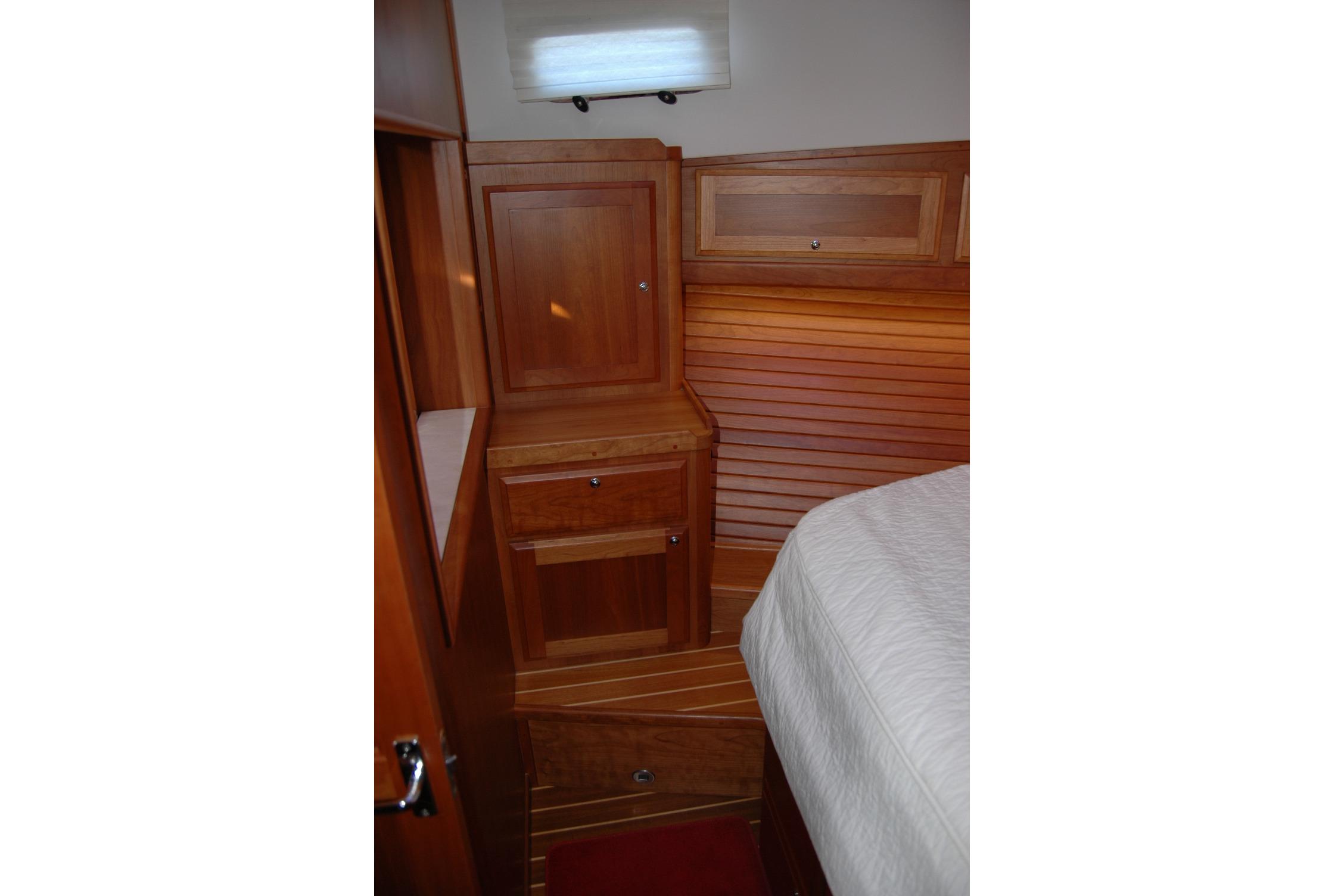 2019 Sabre 38 Salon Express cabin interior with wooden cabinetry and bed.