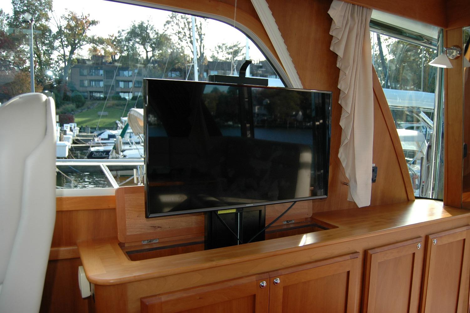 2019 Sabre 38 Salon Express interior with TV and wooden cabinetry.