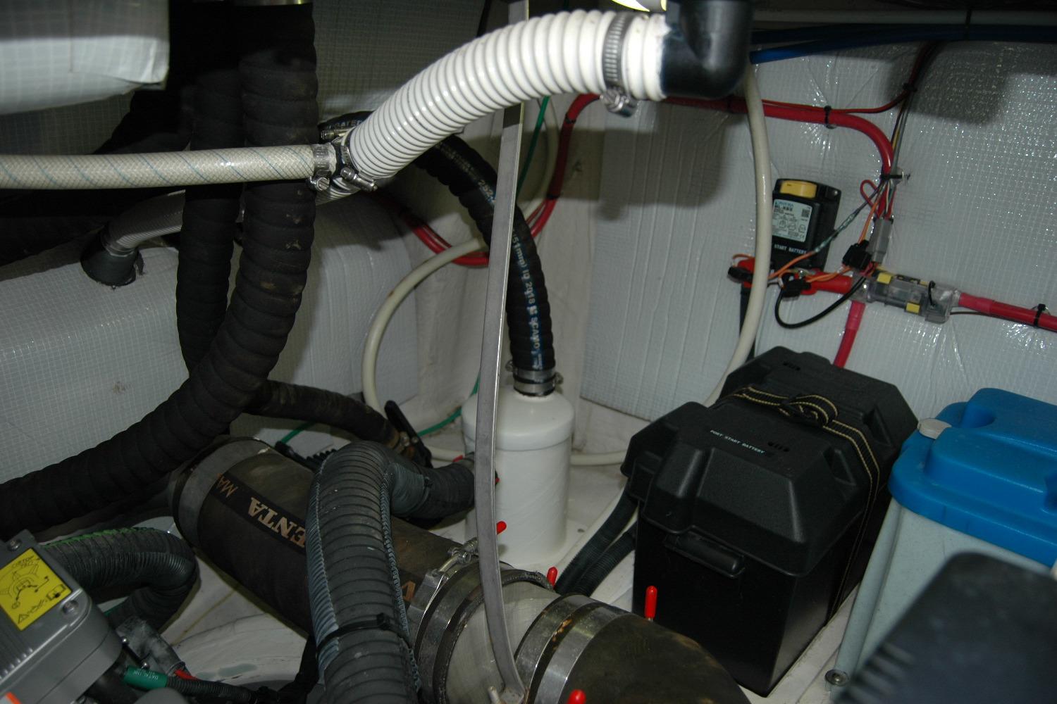 Engine room of 2019 Sabre 38 Salon Express with various hoses and equipment.