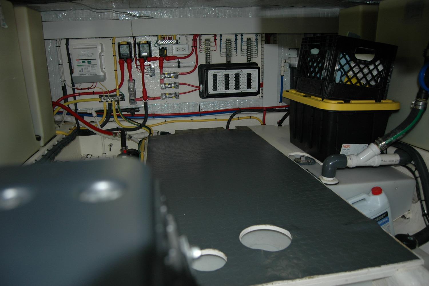 Engine room of 2019 Sabre 38 Salon Express with wiring and storage crates.