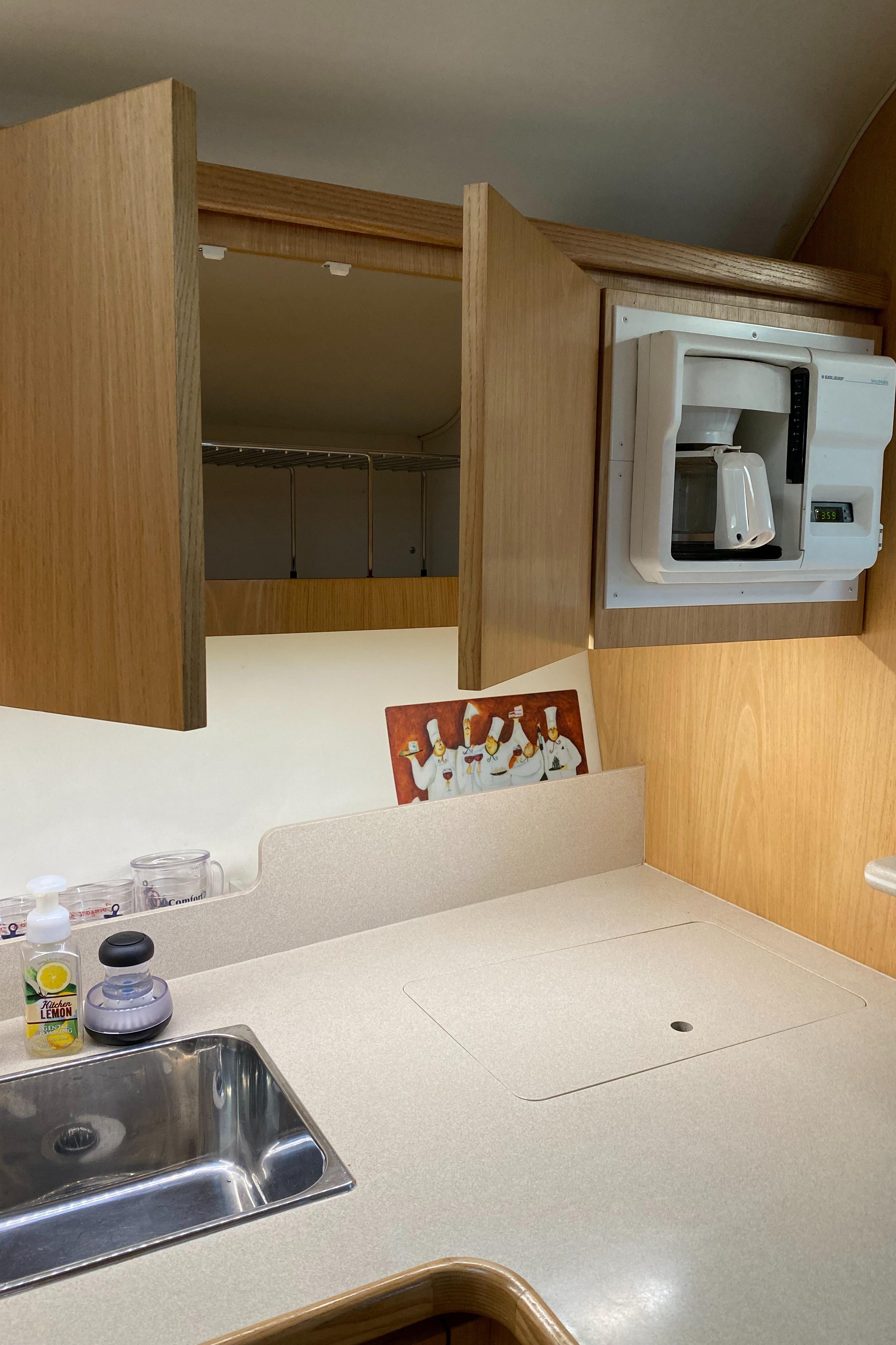TIARA 4000 Galley overhead storage cabinets, coffee maker, note Corian counters, dry locker in corner