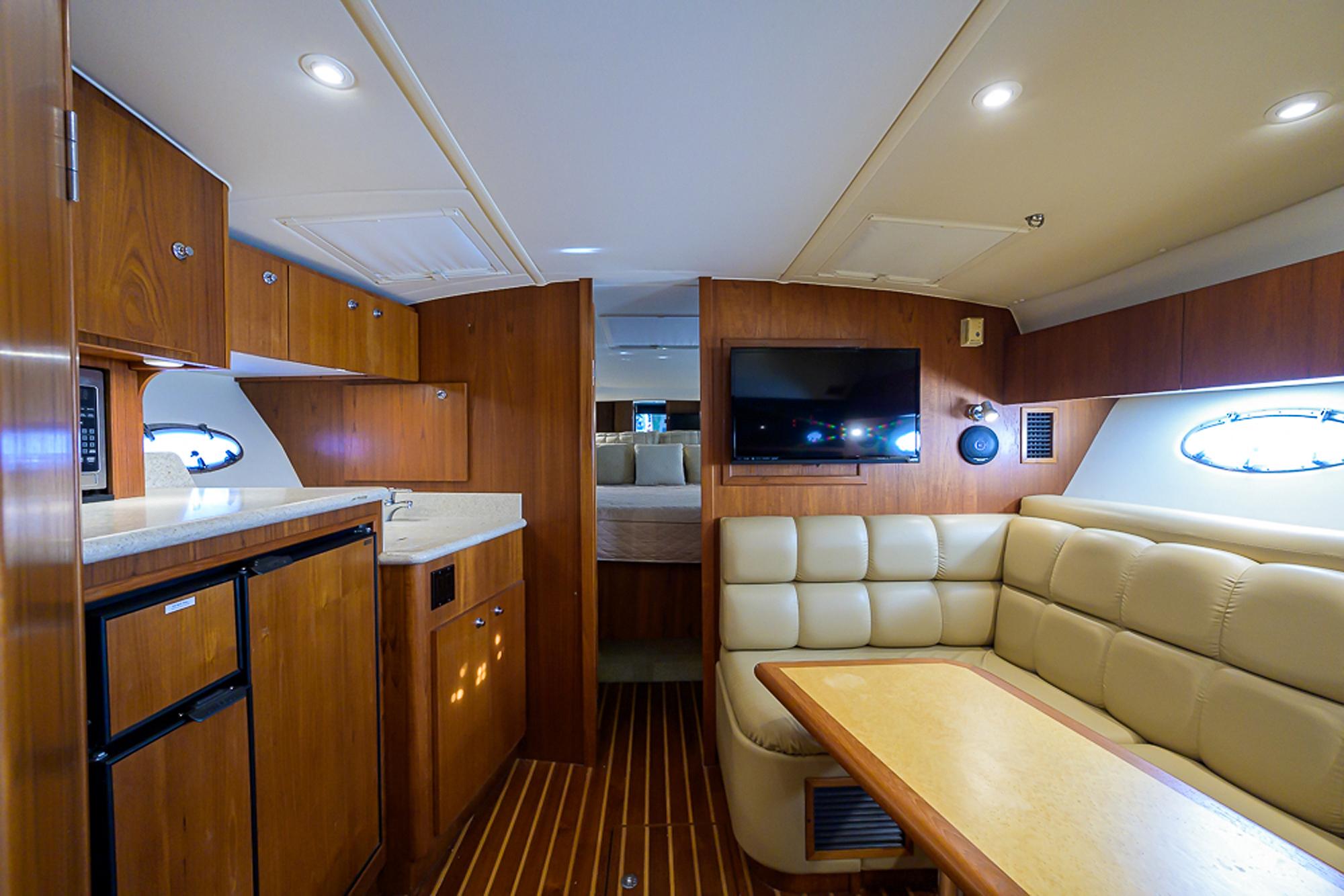 Tiara Yachts 35 Dorado - Interior photo of galley, table and seating