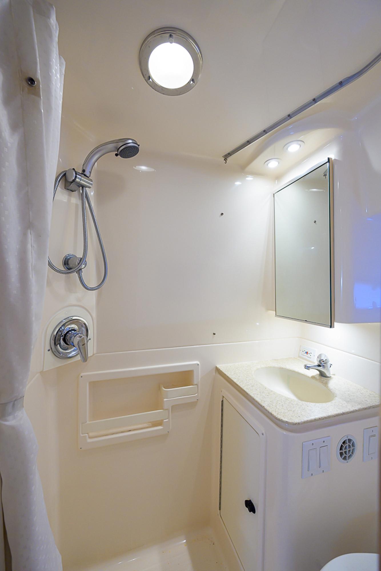 Tiara Yachts 35 Dorado - Interior photo of head, shower, sink with vanity and mirror