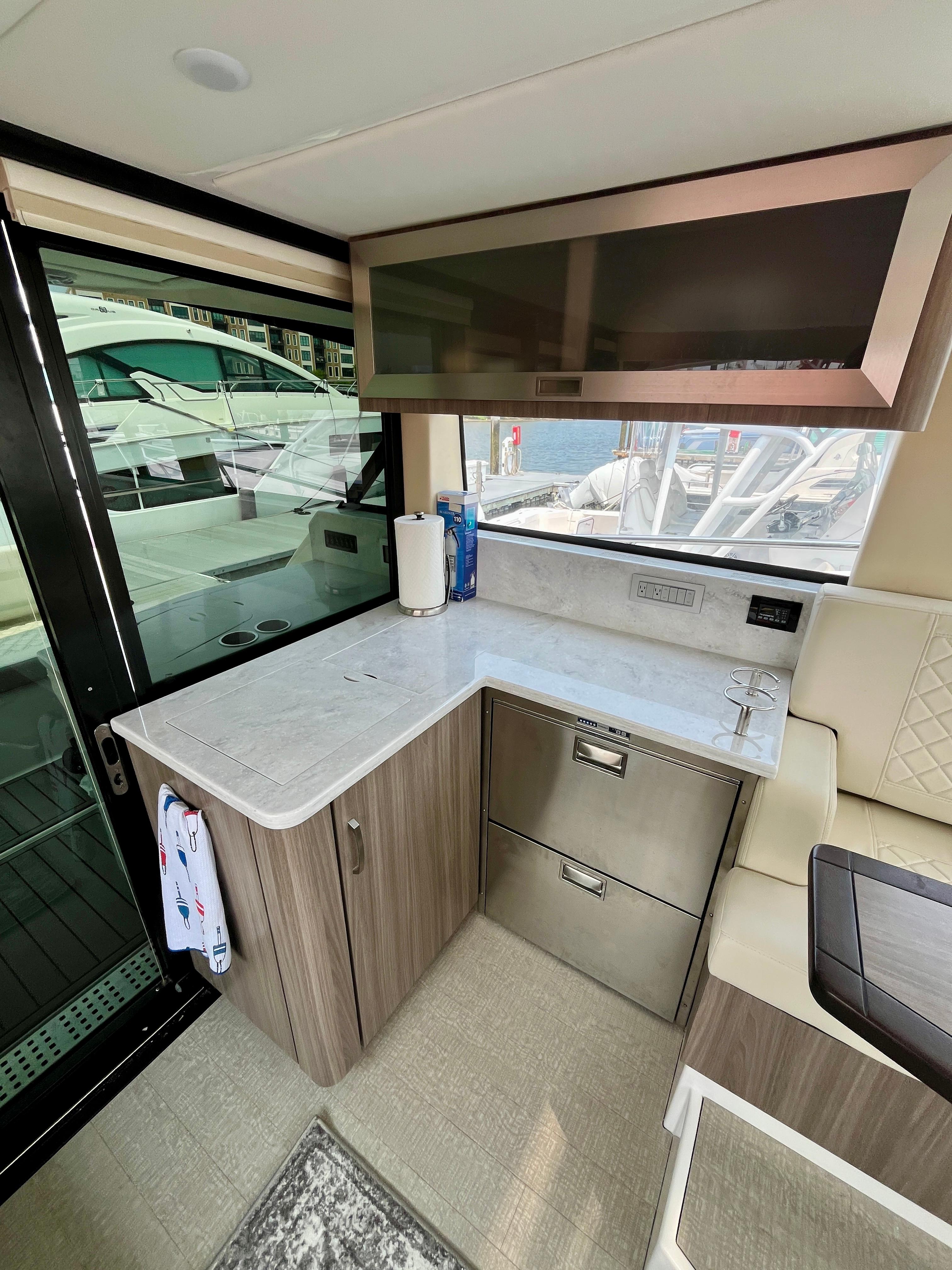Interior of 2022 Regal 38 XO yacht with modern kitchenette and sleek design.