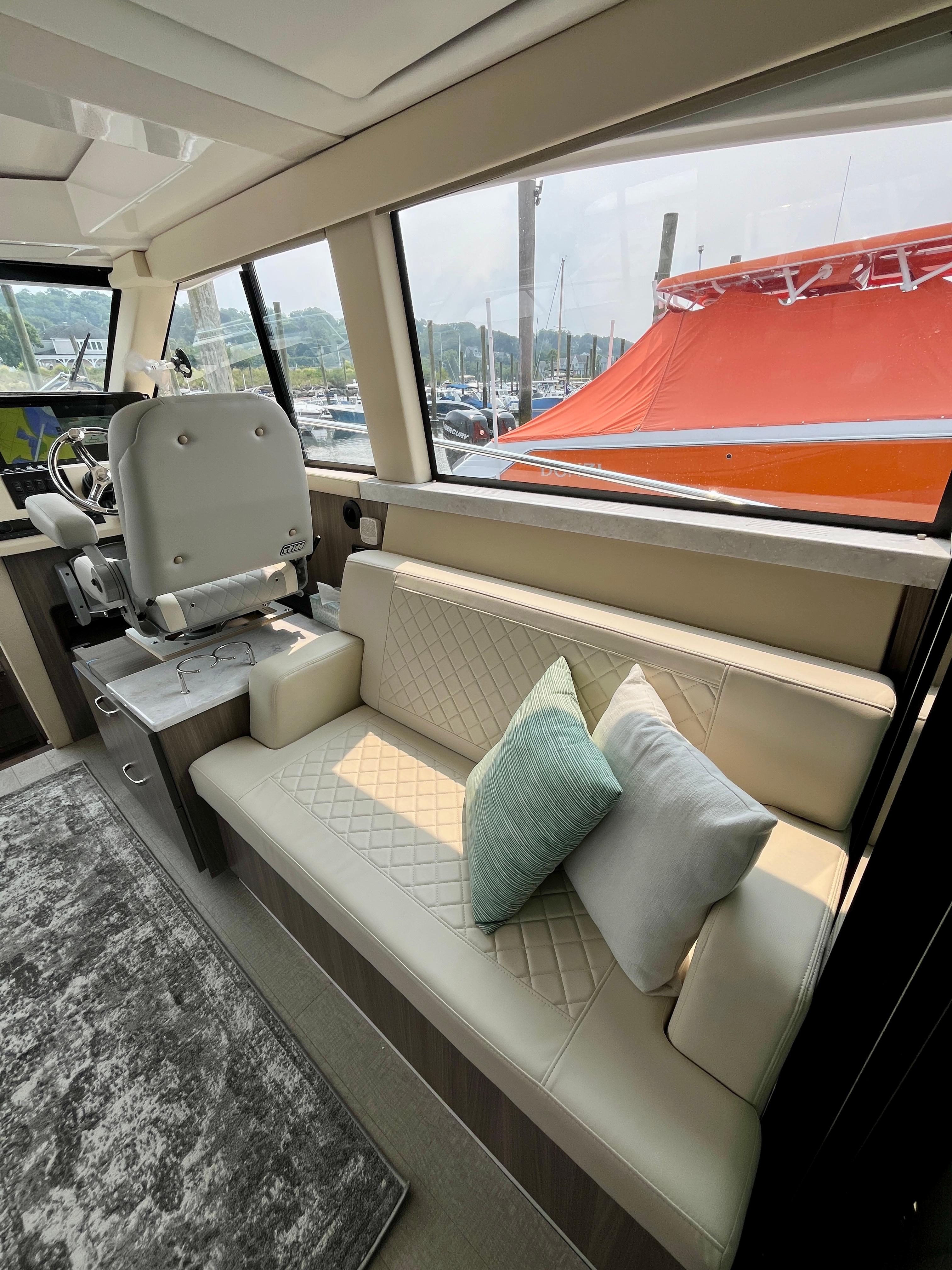 Interior of 2022 Regal 38 XO yacht with plush seating and helm station.