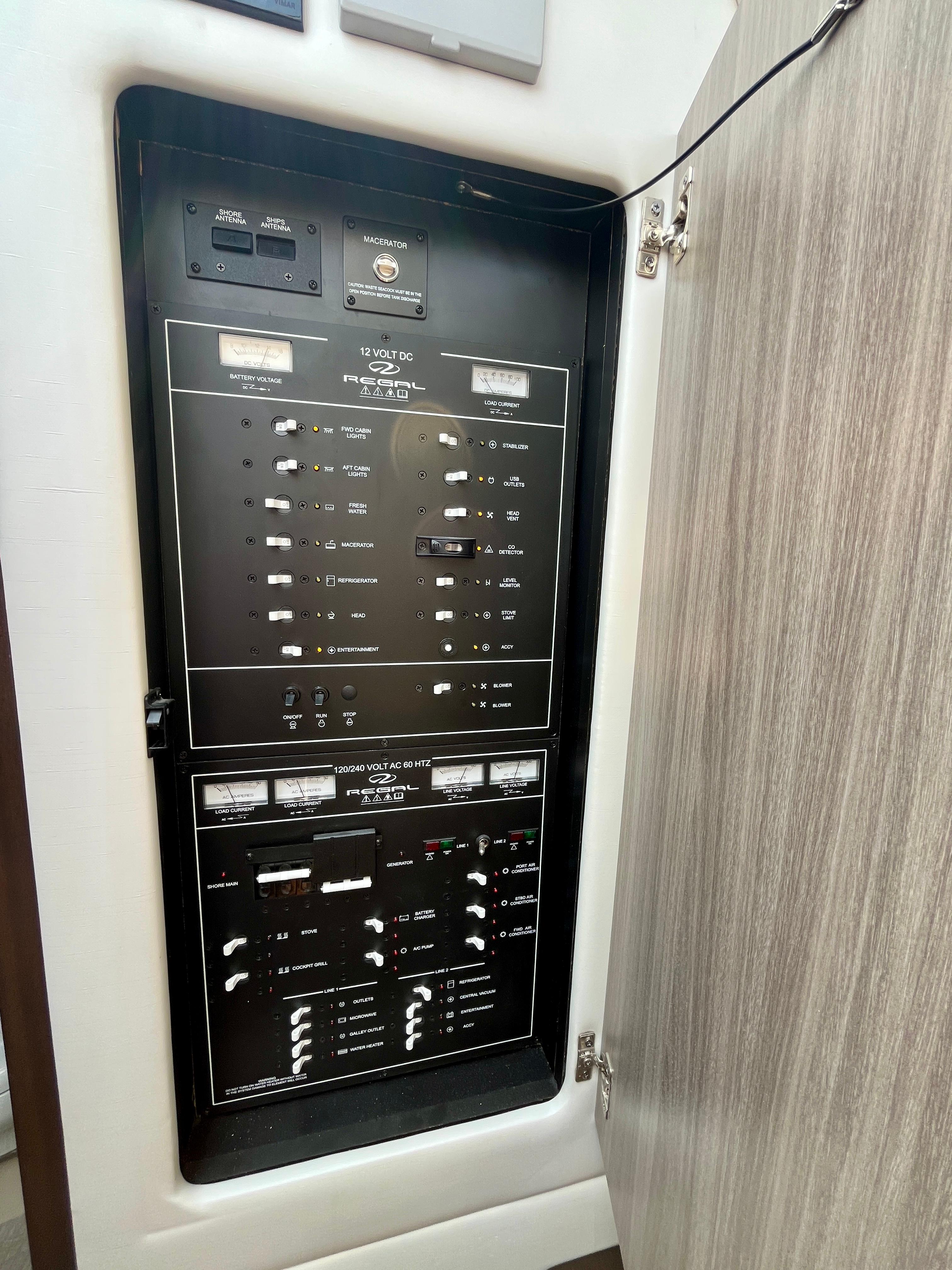 Electrical panel inside 2022 Regal 38 XO boat, featuring various switches and controls.