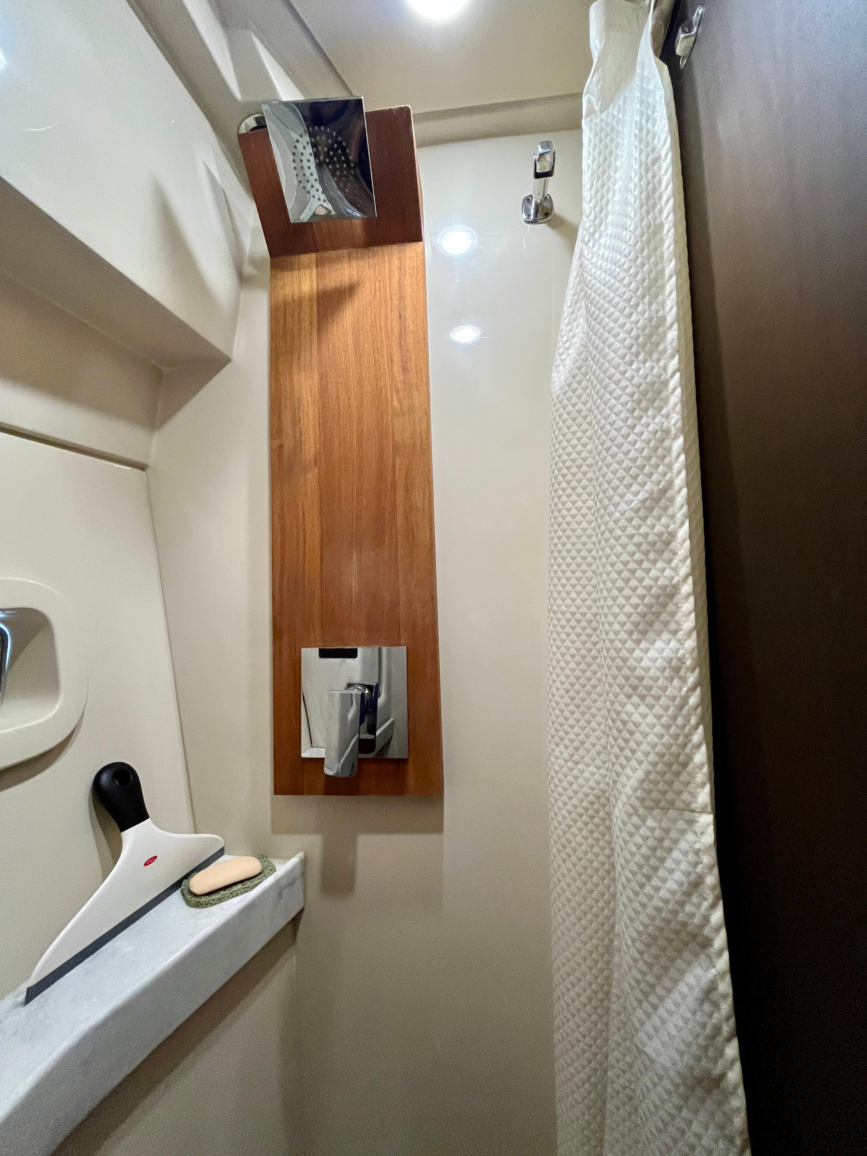 2022 Regal 38 XO yacht bathroom with modern shower and curtain.