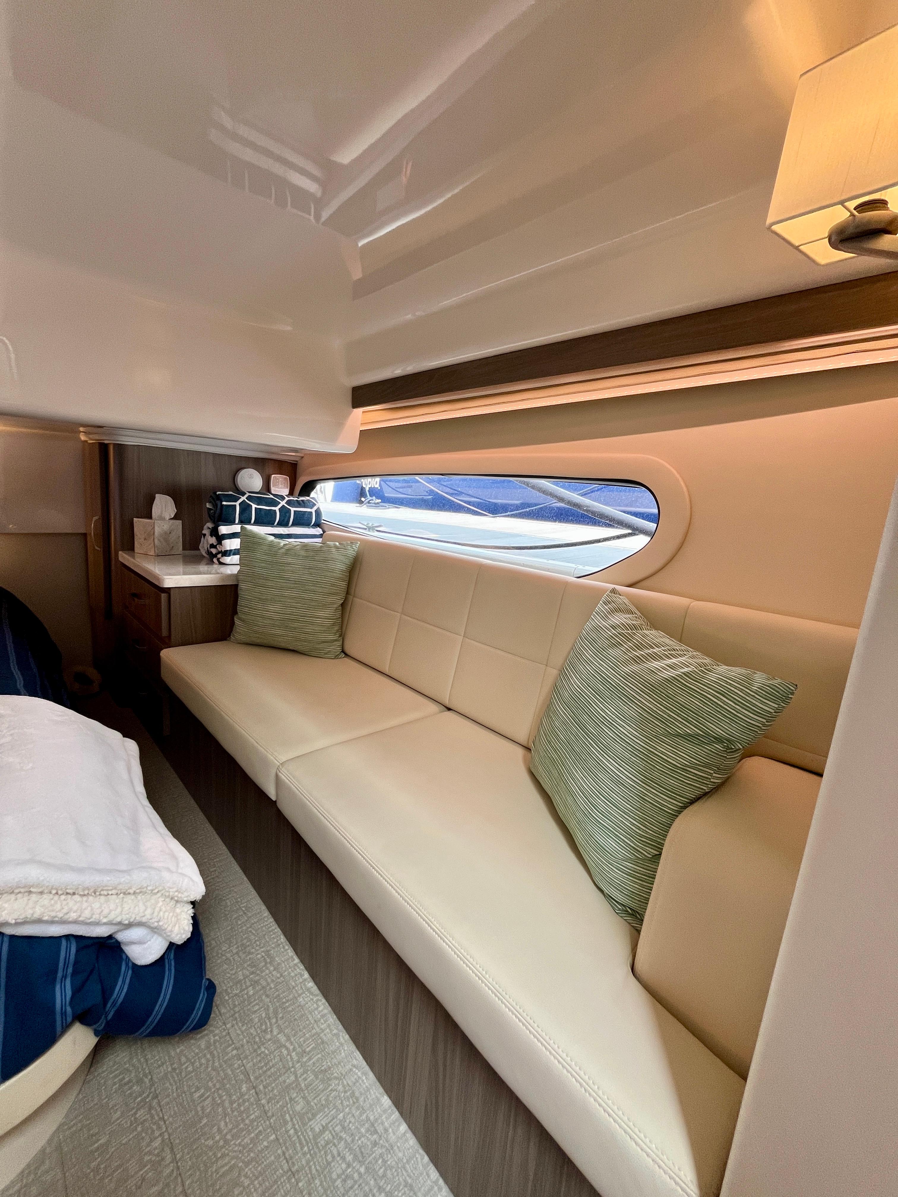 Luxurious interior of 2022 Regal 38 XO yacht with plush seating and elegant decor.