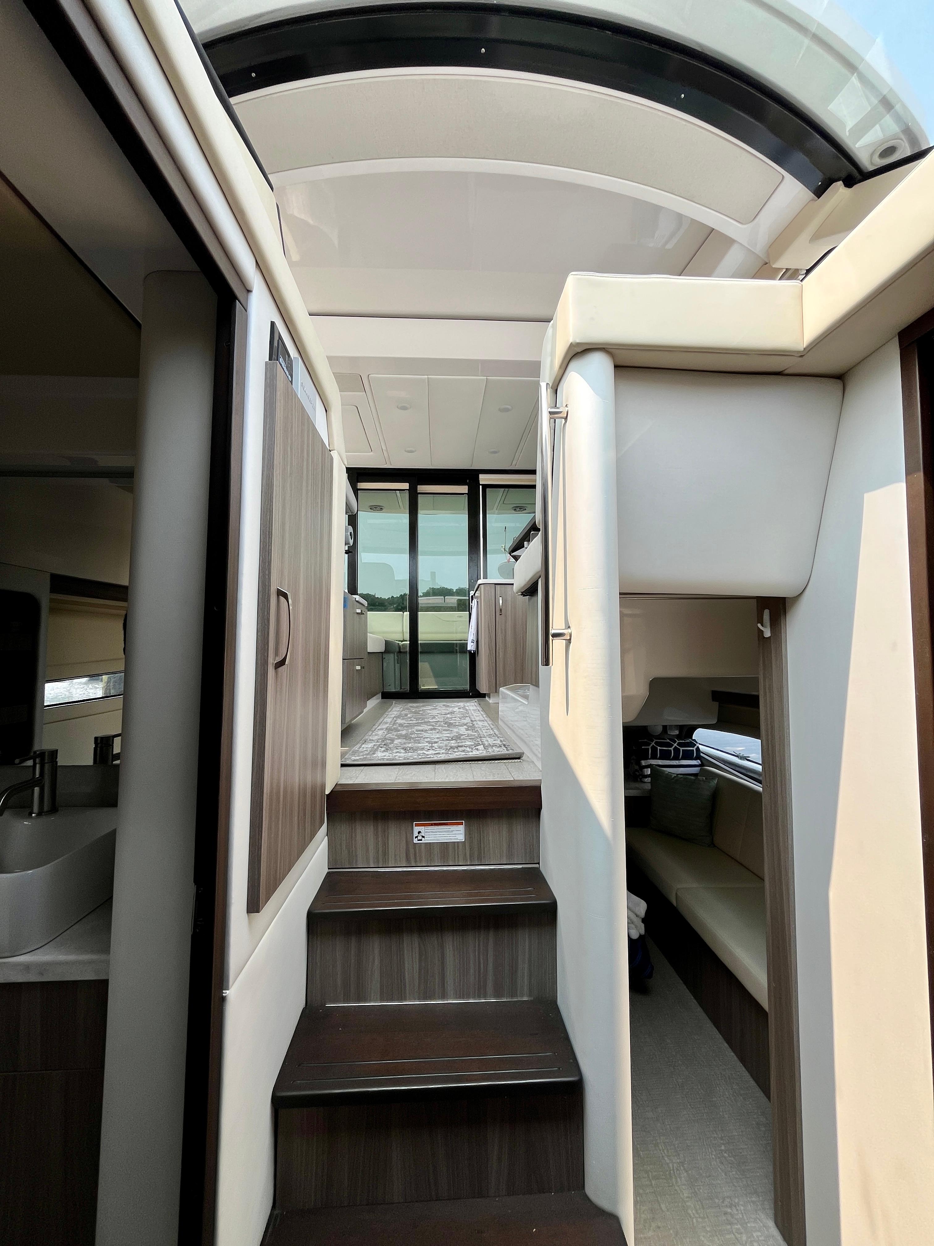 Interior view of 2022 Regal 38 XO yacht, featuring modern design and elegant wood finishes.