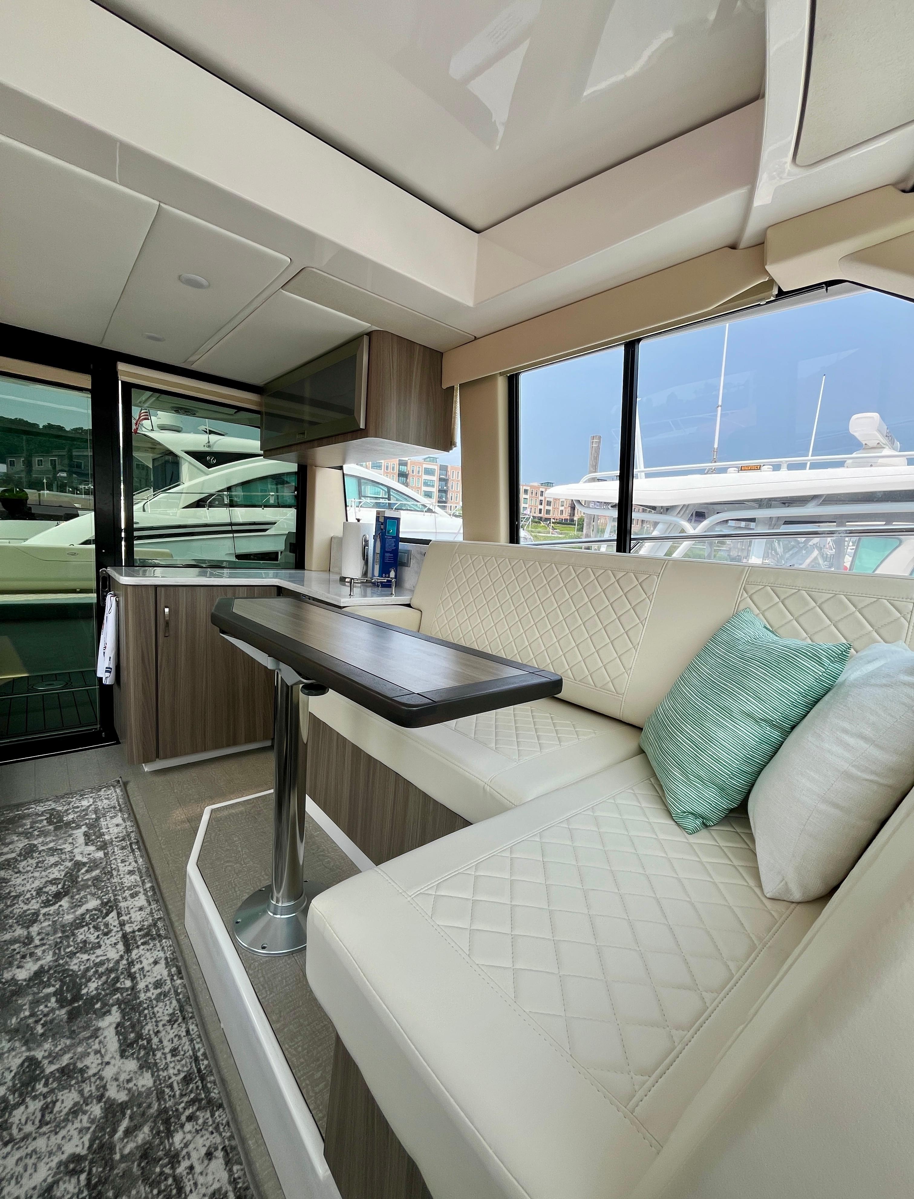 Interior of 2022 Regal 38 XO yacht with modern seating and table.